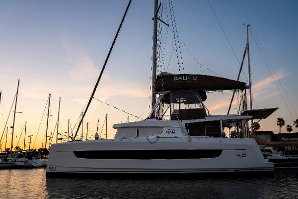 2021 Bali 4.8 catamaran docked at sunset, showcasing sleek design and modern features.