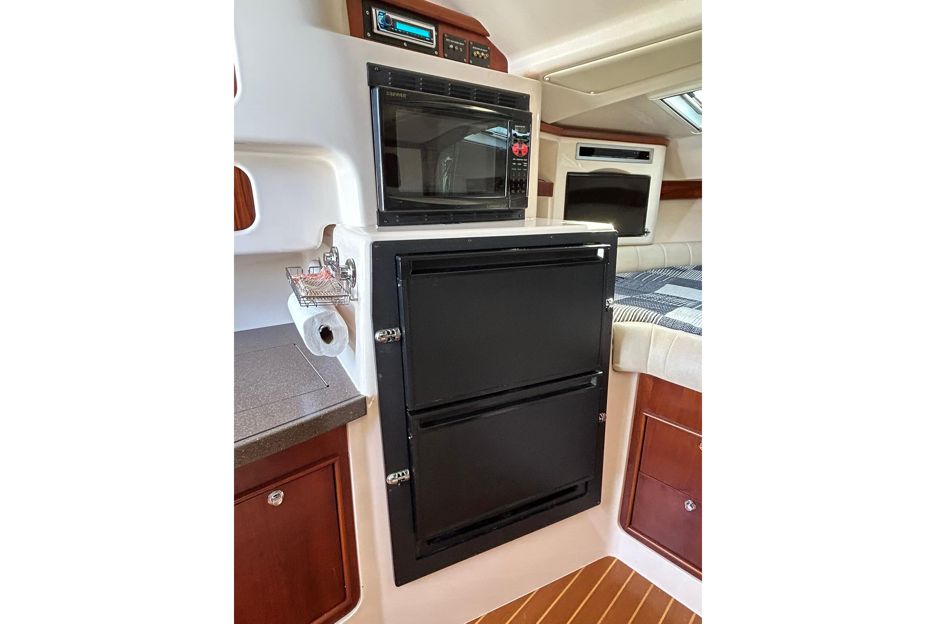 2007 Grady-White Express 360 interior with microwave, fridge, and cozy cabin space.
