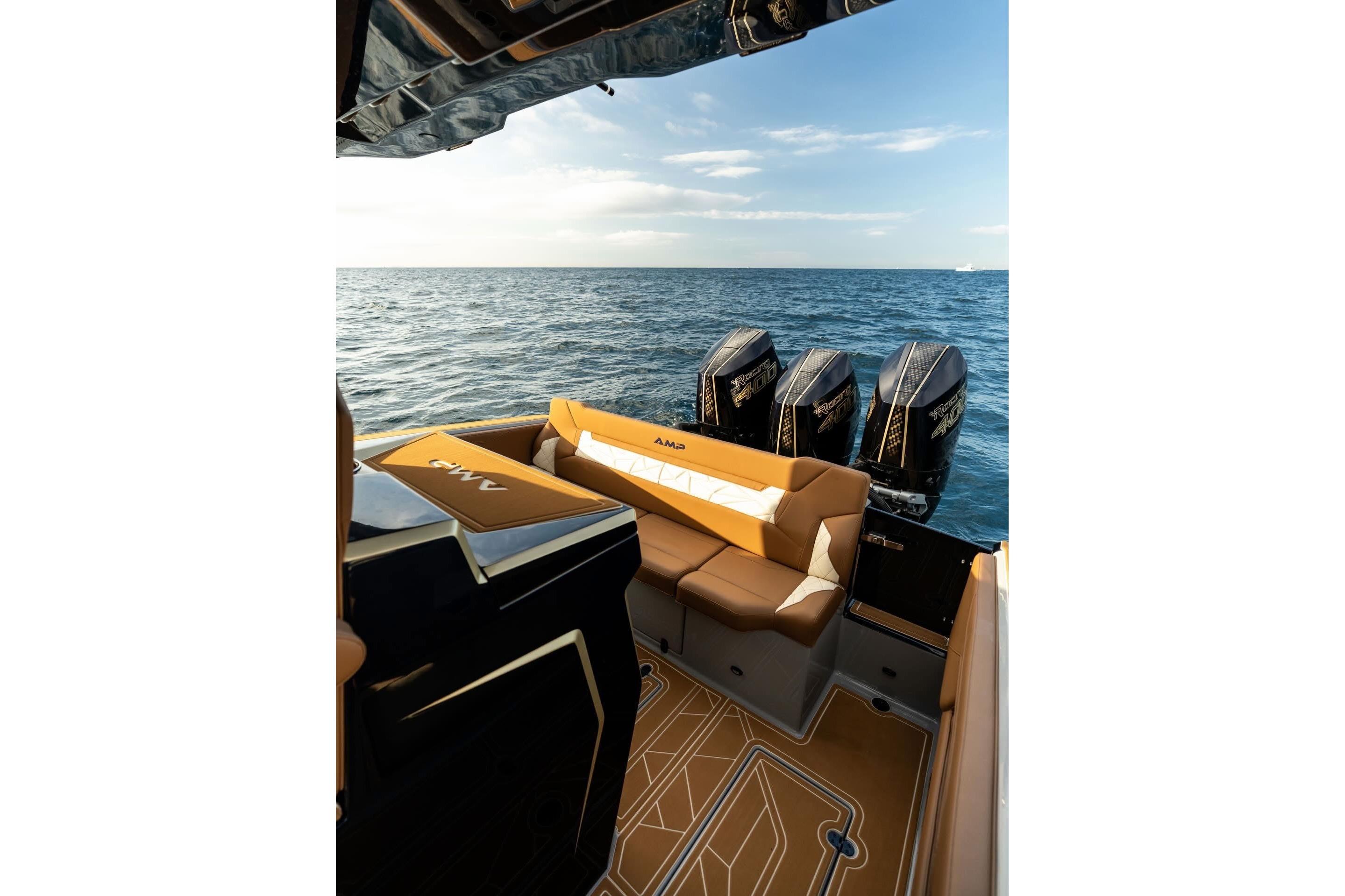 Luxury AMP 34S boat interior with triple outboard motors, 2027 model, on open sea.