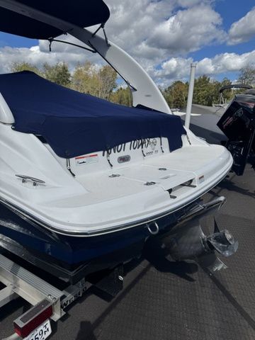 2022 Regal 2000 ES boat on trailer, covered, with outboard motor, under a partly cloudy sky.