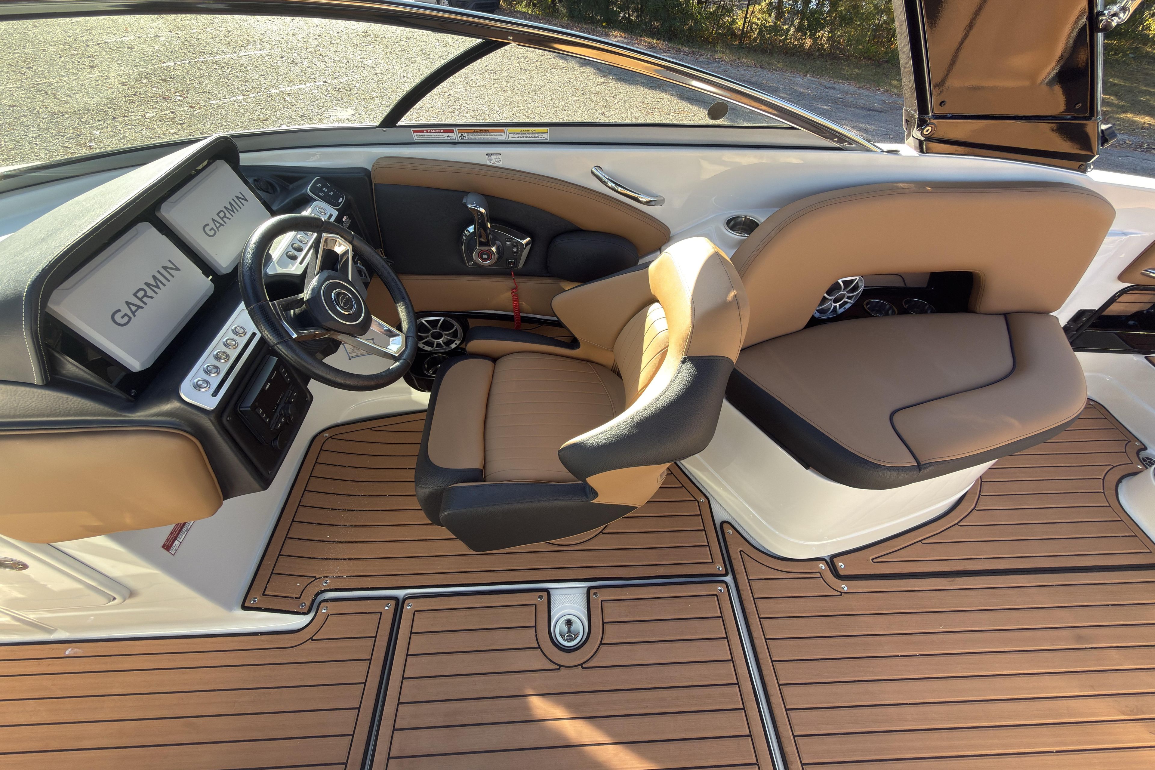 2026 Crownline 298 SS boat interior with Garmin displays and tan seating.