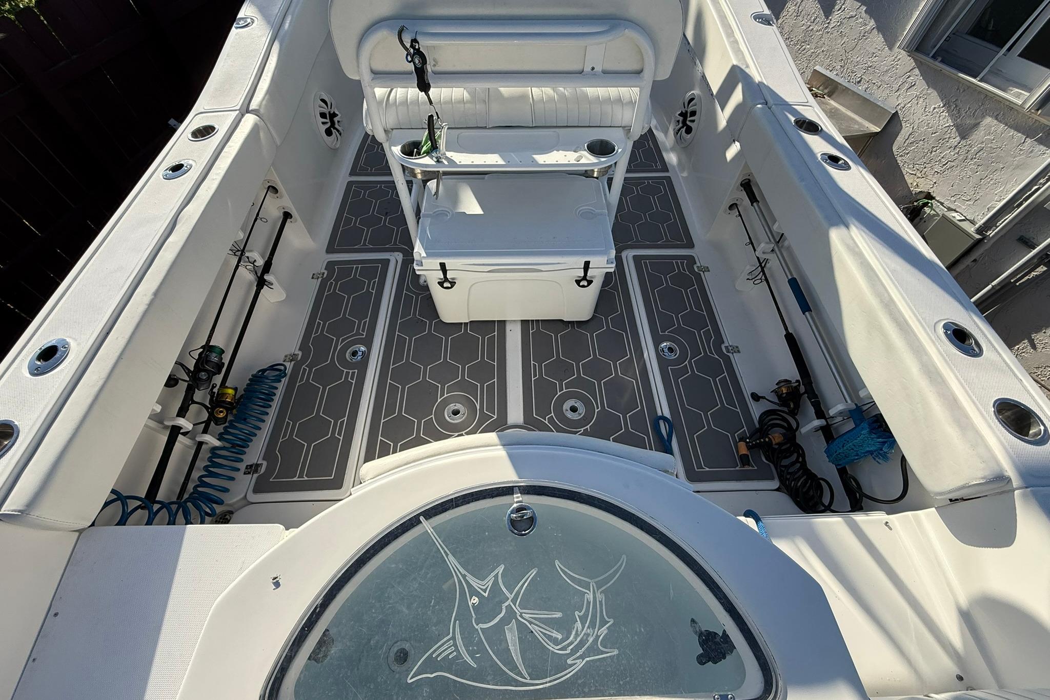2014 Sea Fox 256 Commander boat interior with seating and fishing rod holders.