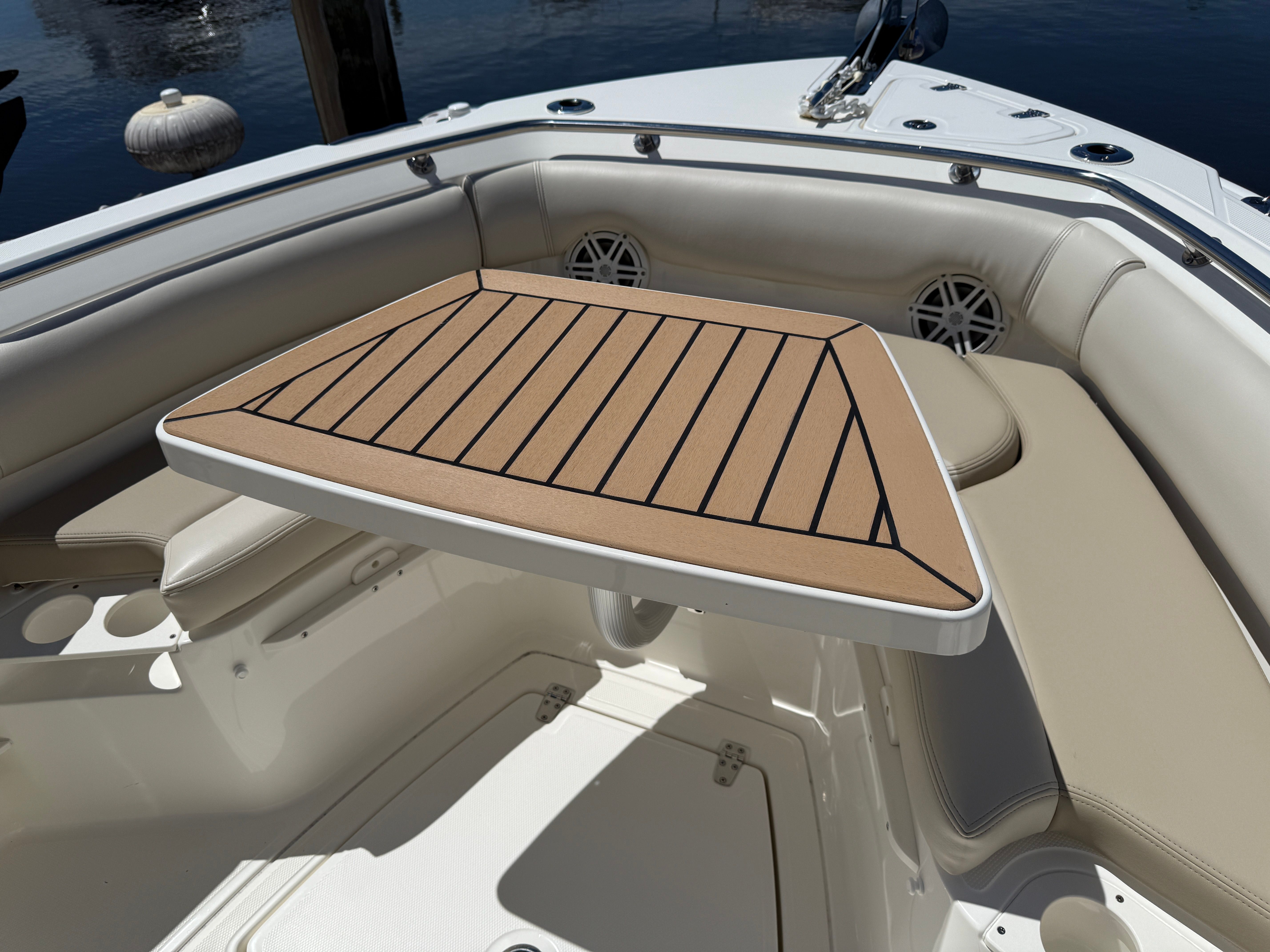 Interior of 2024 Boston Whaler 230 Outrage with table and seating area.
