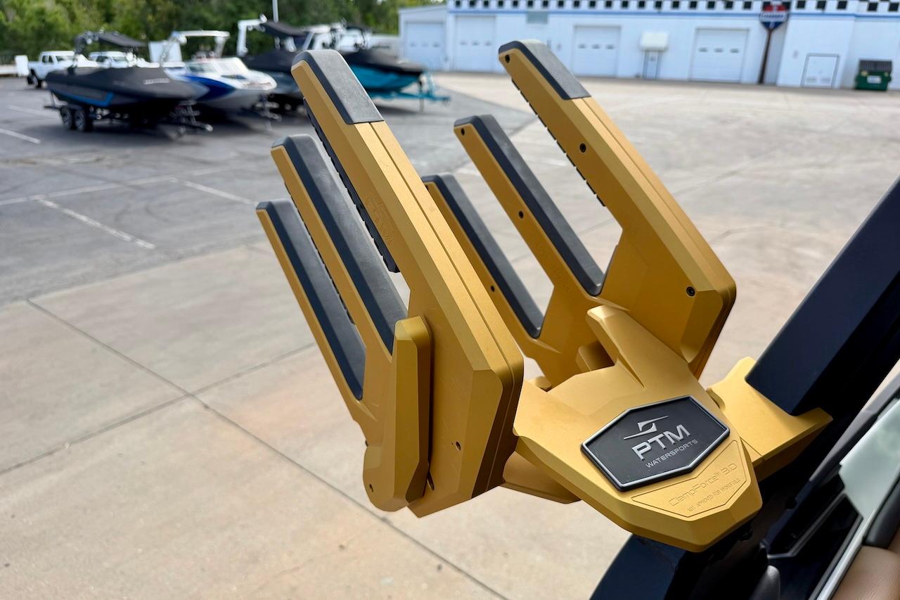 Golden PTM Watersports rack on 2025 Tigé Ultré 25ZX boat, with other boats in background.