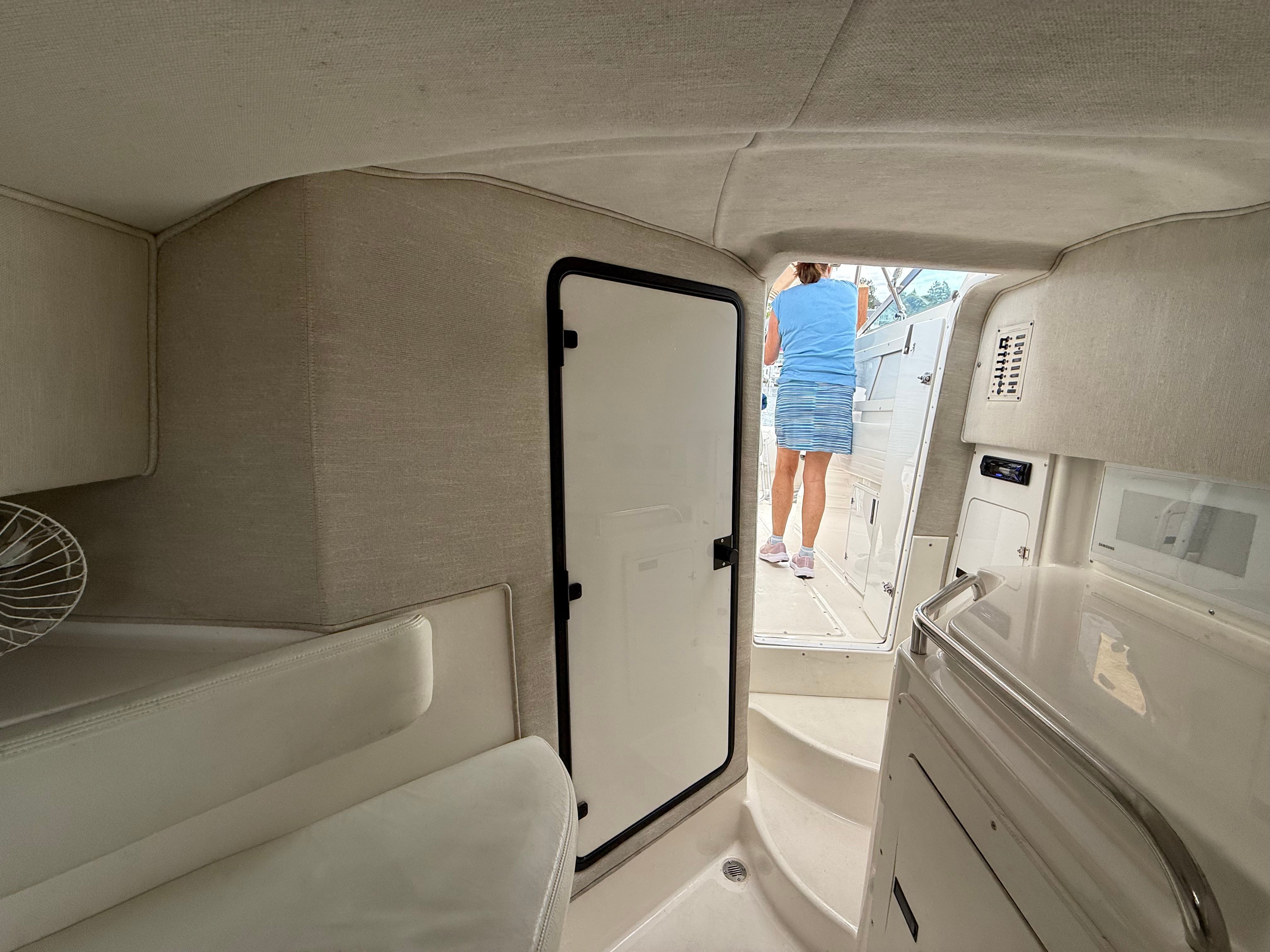 Interior of a 1999 Fountain 32 Sport Fish Cruiser with open door.