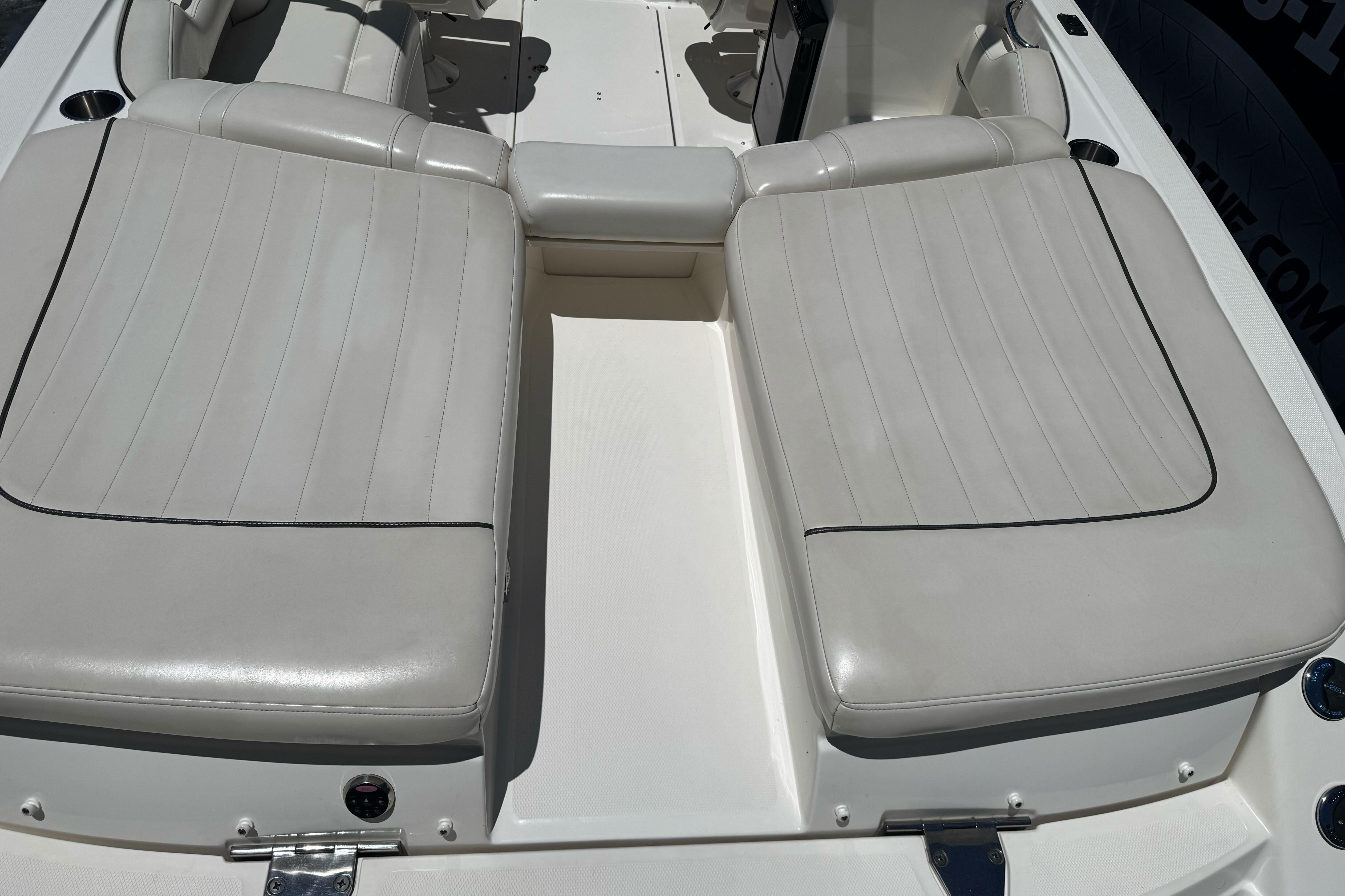 2007 Sea Ray SLX 250 boat interior with white cushioned seating.