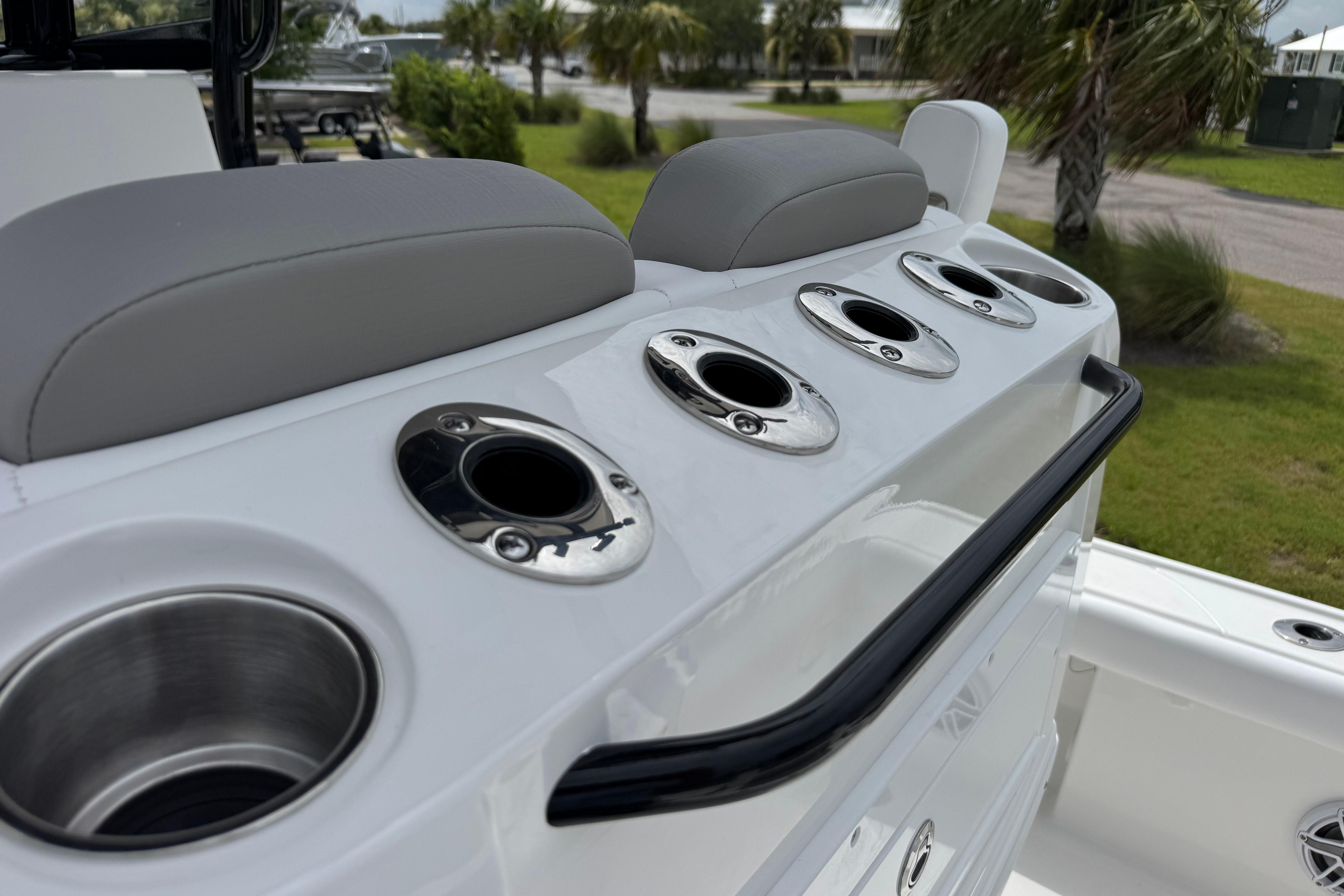 2027 Caymas 26 HB boat with rod holders and cup holders on deck.