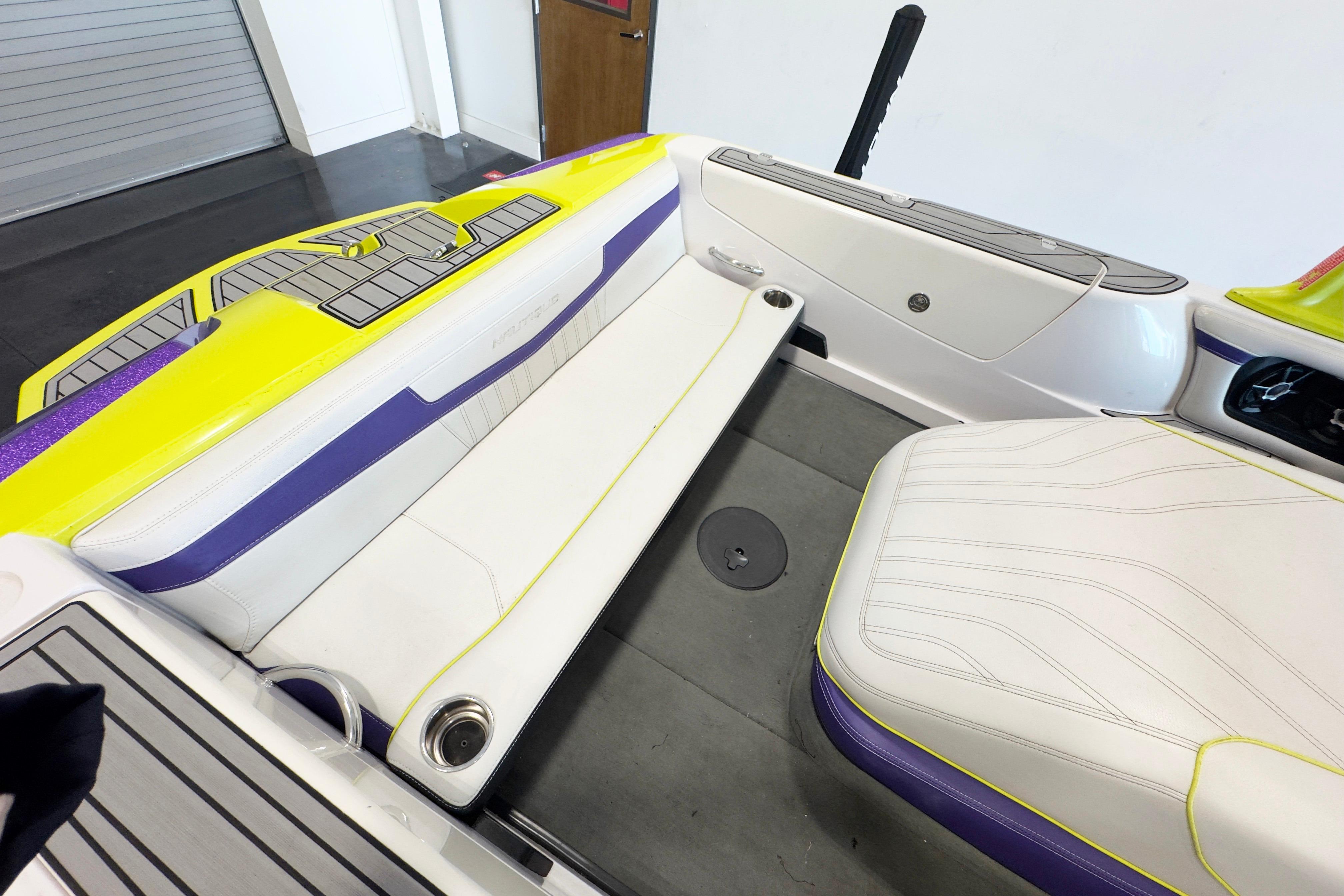 2014 Nautique Ski Nautique 200 interior with white and purple seating, yellow accents.