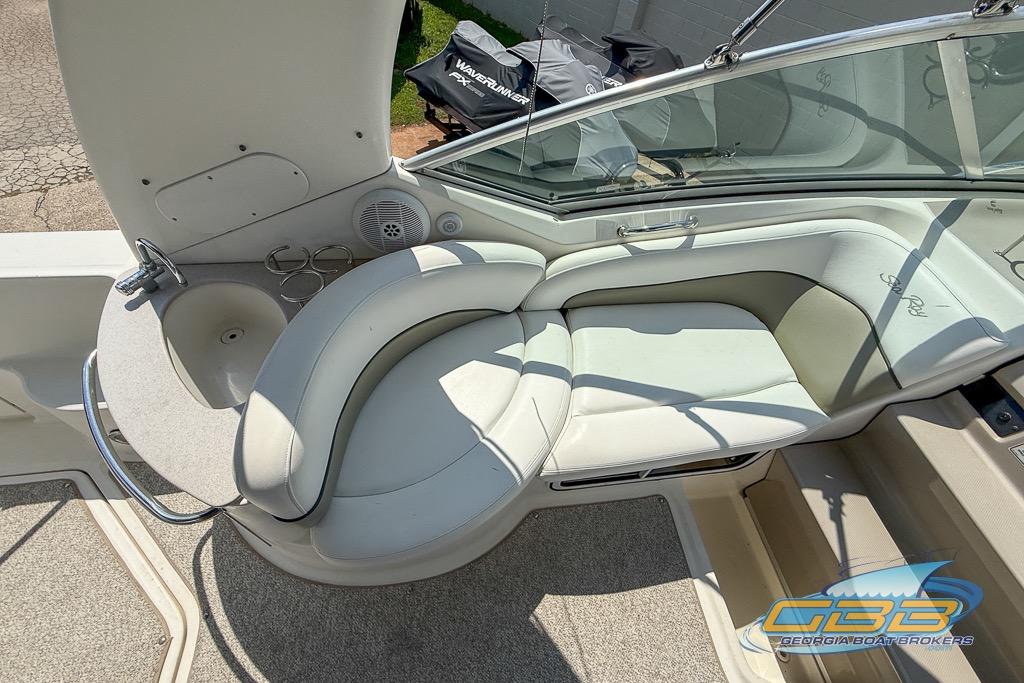 Interior of 2006 Sea Ray Sundancer 260 with curved seating and sink.