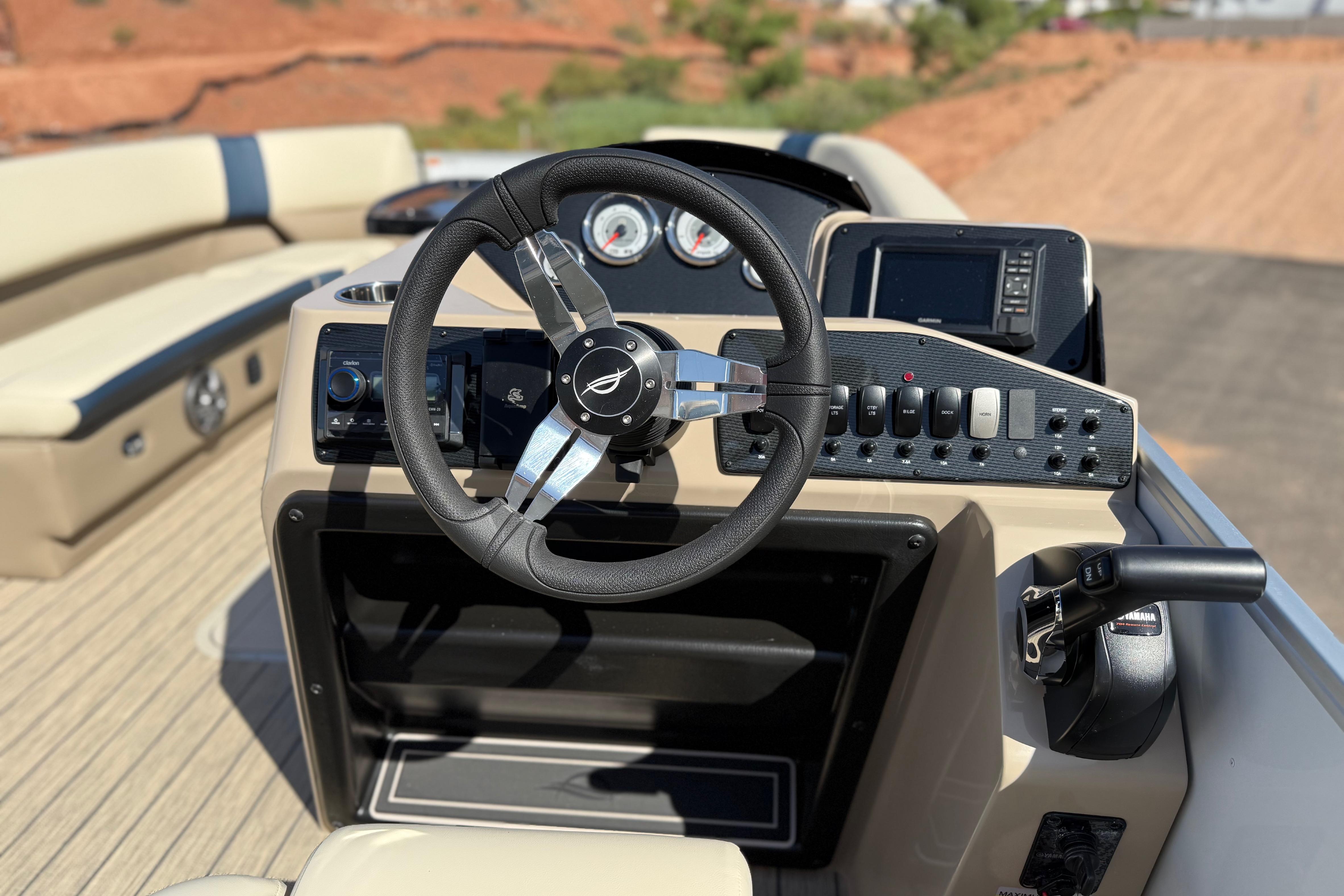 Steering console of 2026 SunCatcher Select 322SL boat with modern controls and dashboard.