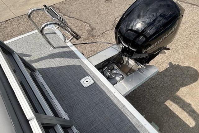 2026 Sun Tracker Party Barge 20 DLX with Mercury outboard motor, rear deck view.