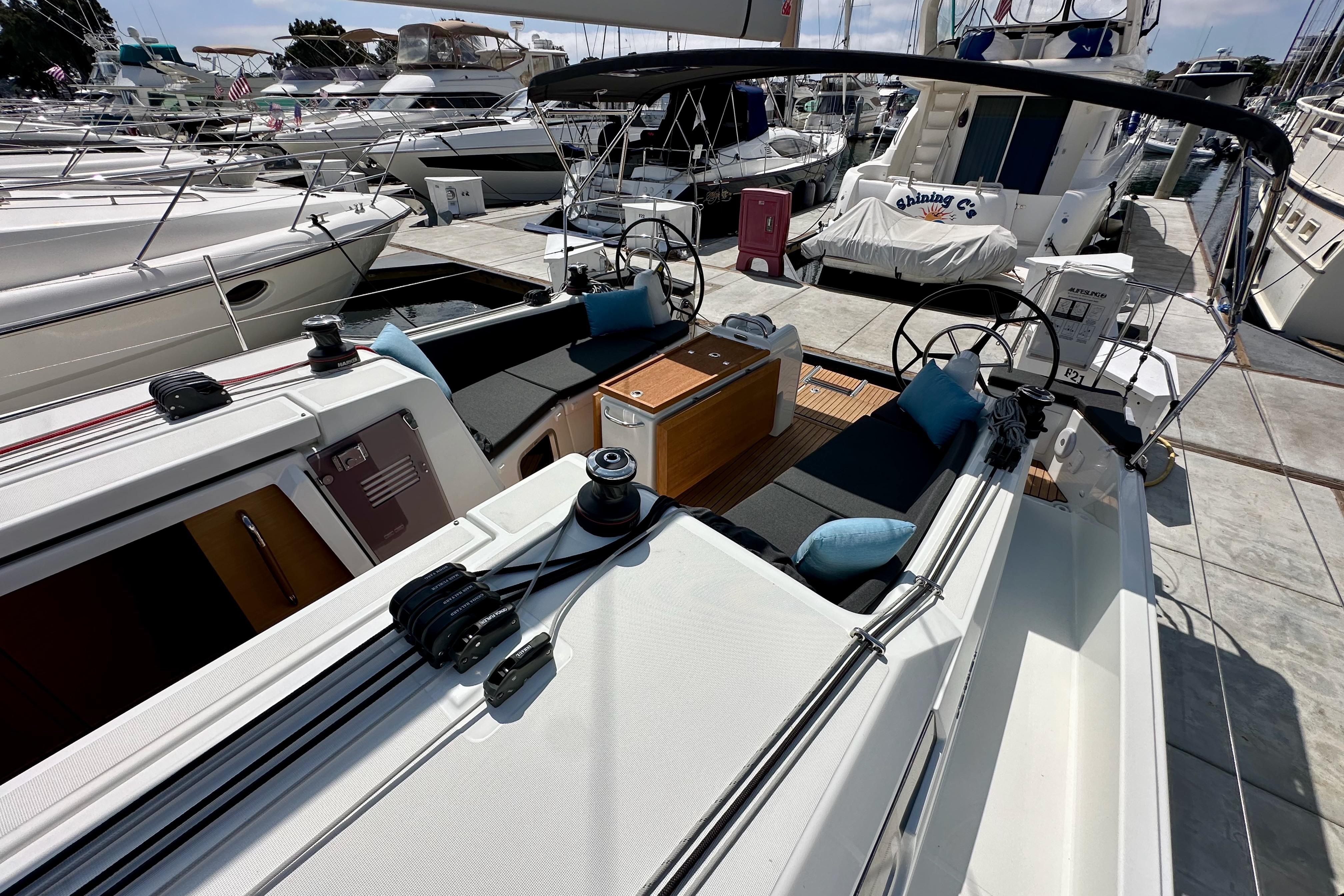 2024 Jeanneau Sun Odyssey 410 sailboat with dual helm, docked at marina.