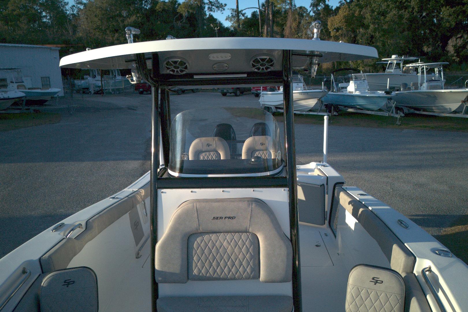 2021 Sea Pro 259 Center Console boat with seating, parked in a marina.