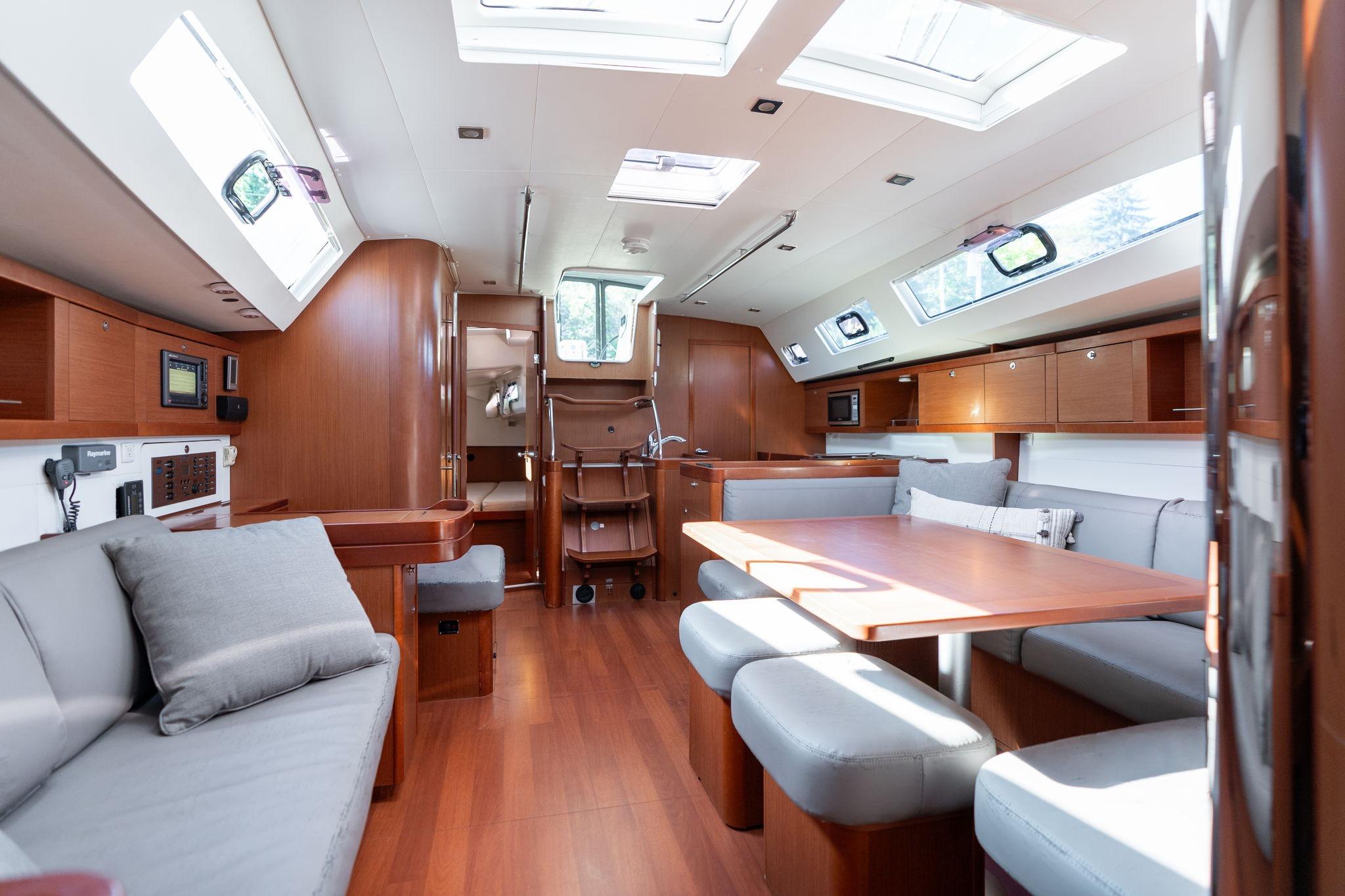 Spacious interior of 2013 Beneteau Oceanis 50 yacht with modern furnishings and ample natural light.