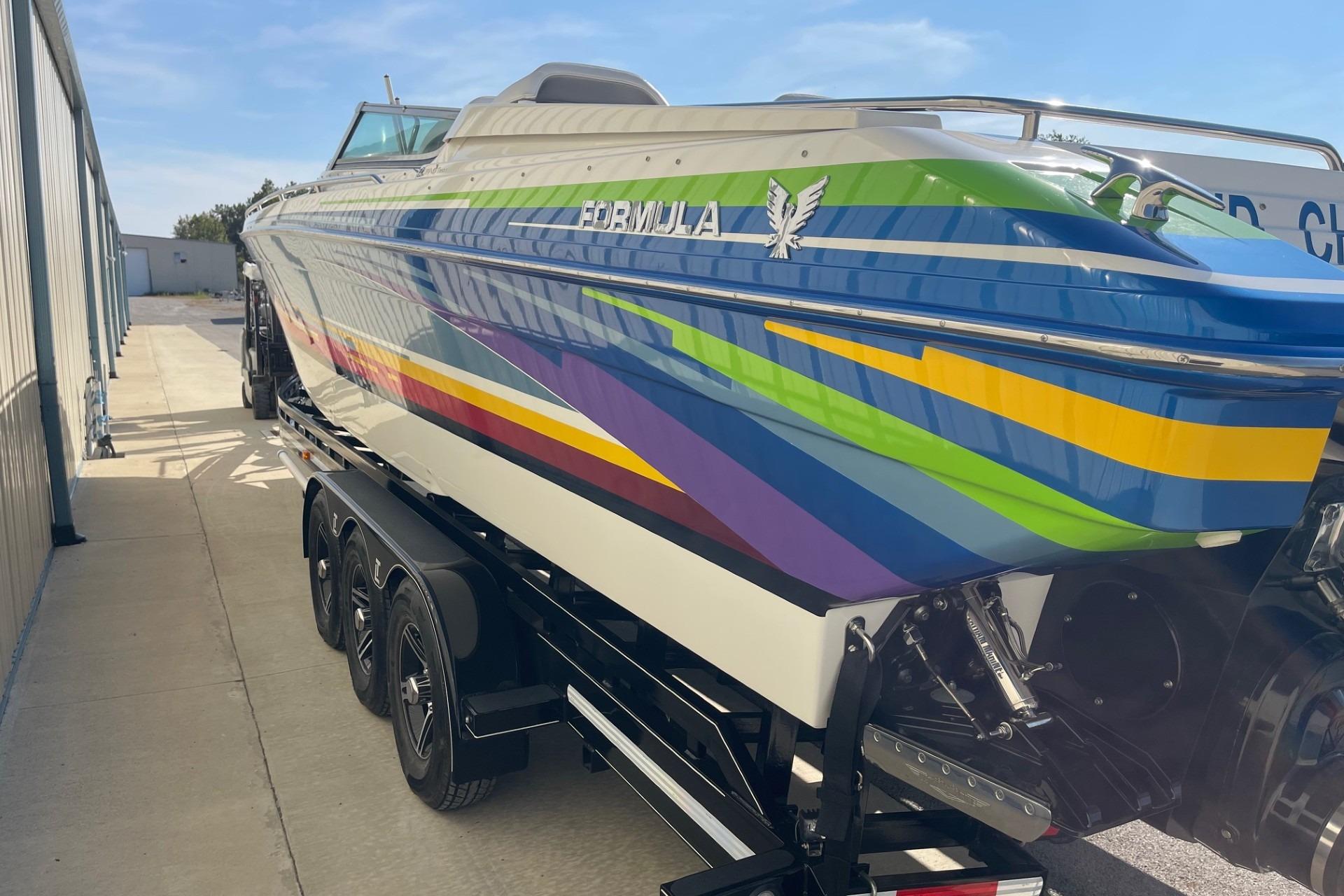 2004 Formula 382 FASTech boat with vibrant stripes on a trailer.
