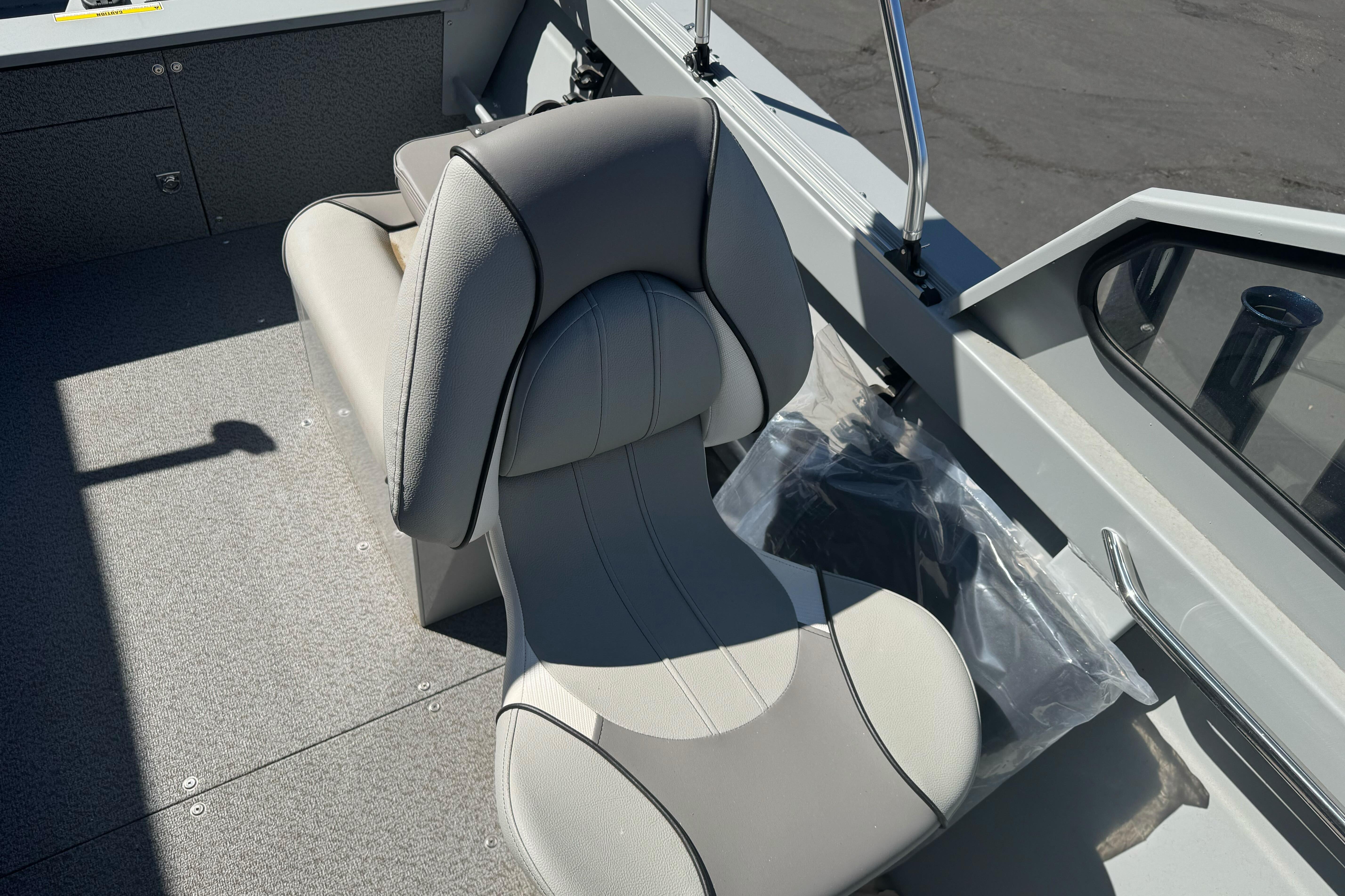 KingFisher 16 Falcon 2026 boat interior with gray cushioned seat and storage area.
