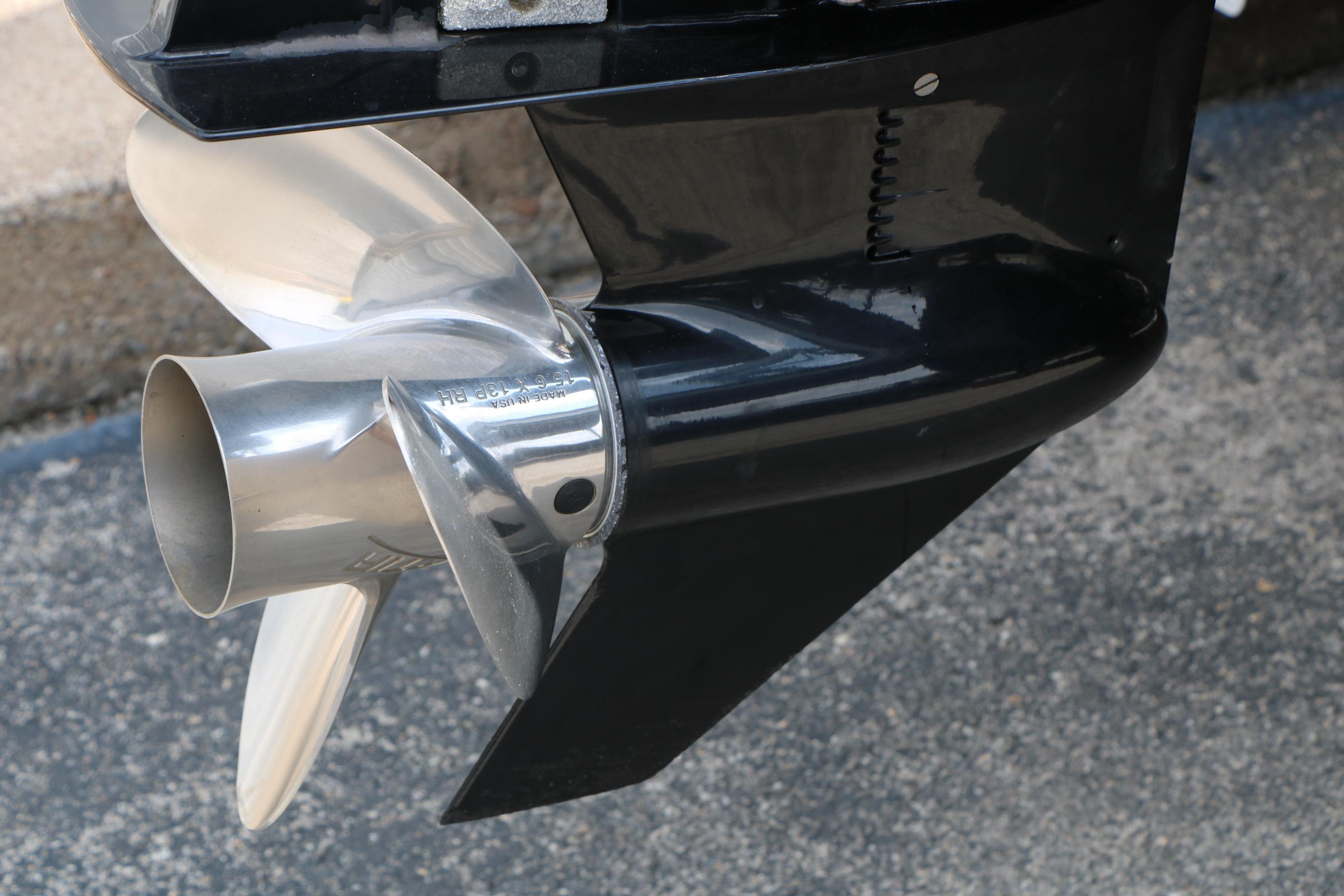 Close-up of a 2021 Ranger 223FC boat propeller on a textured surface.
