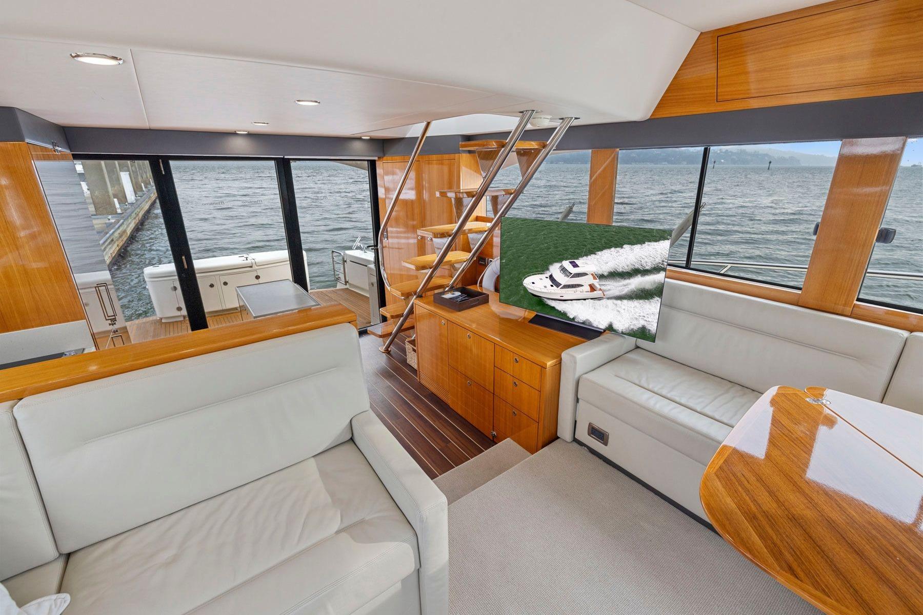 Luxurious interior of 2014 Maritimo M50 yacht with elegant wood finishes and waterfront view.