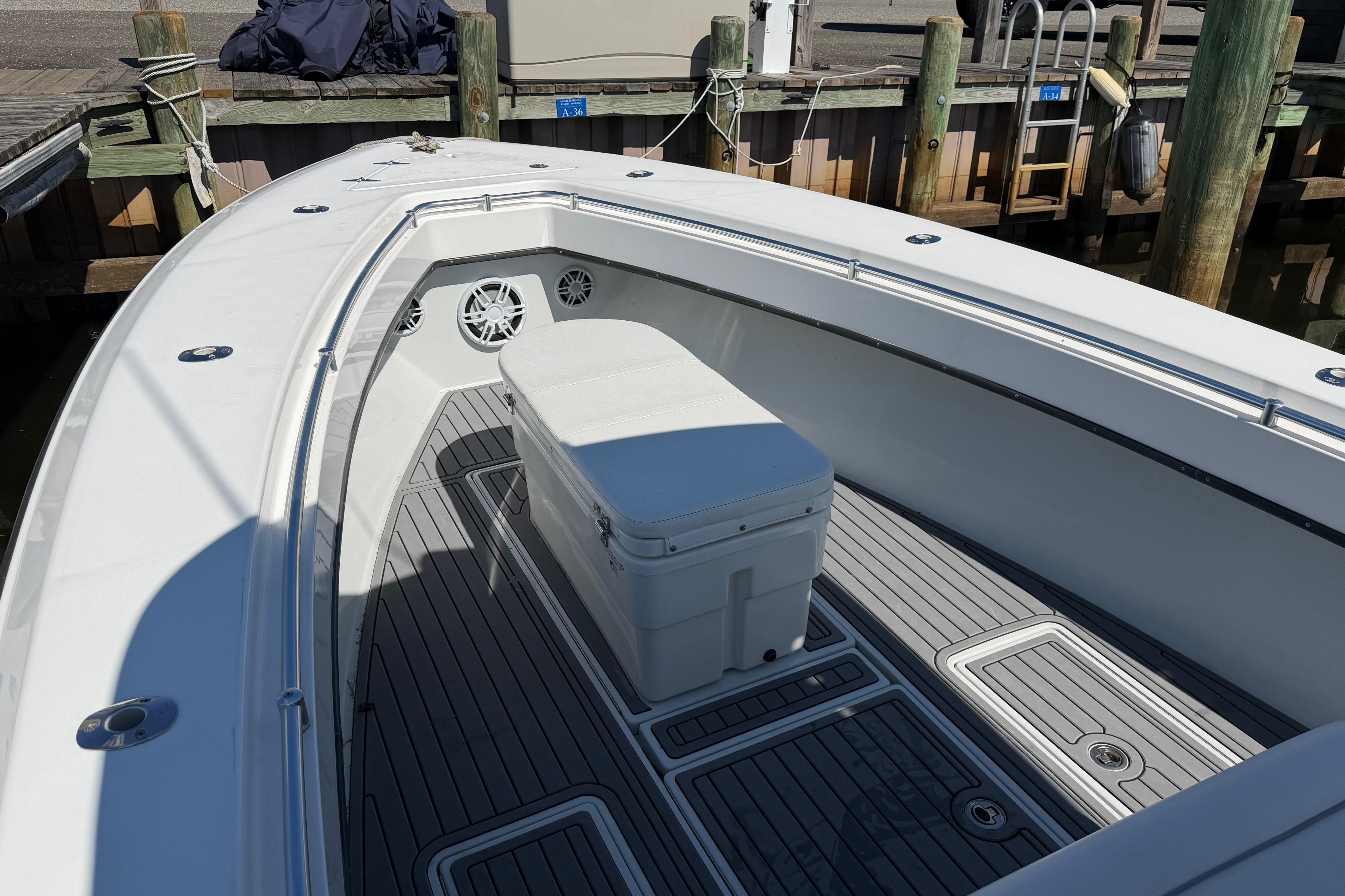 2015 Contender 32 ST boat interior with seating and storage at dock.