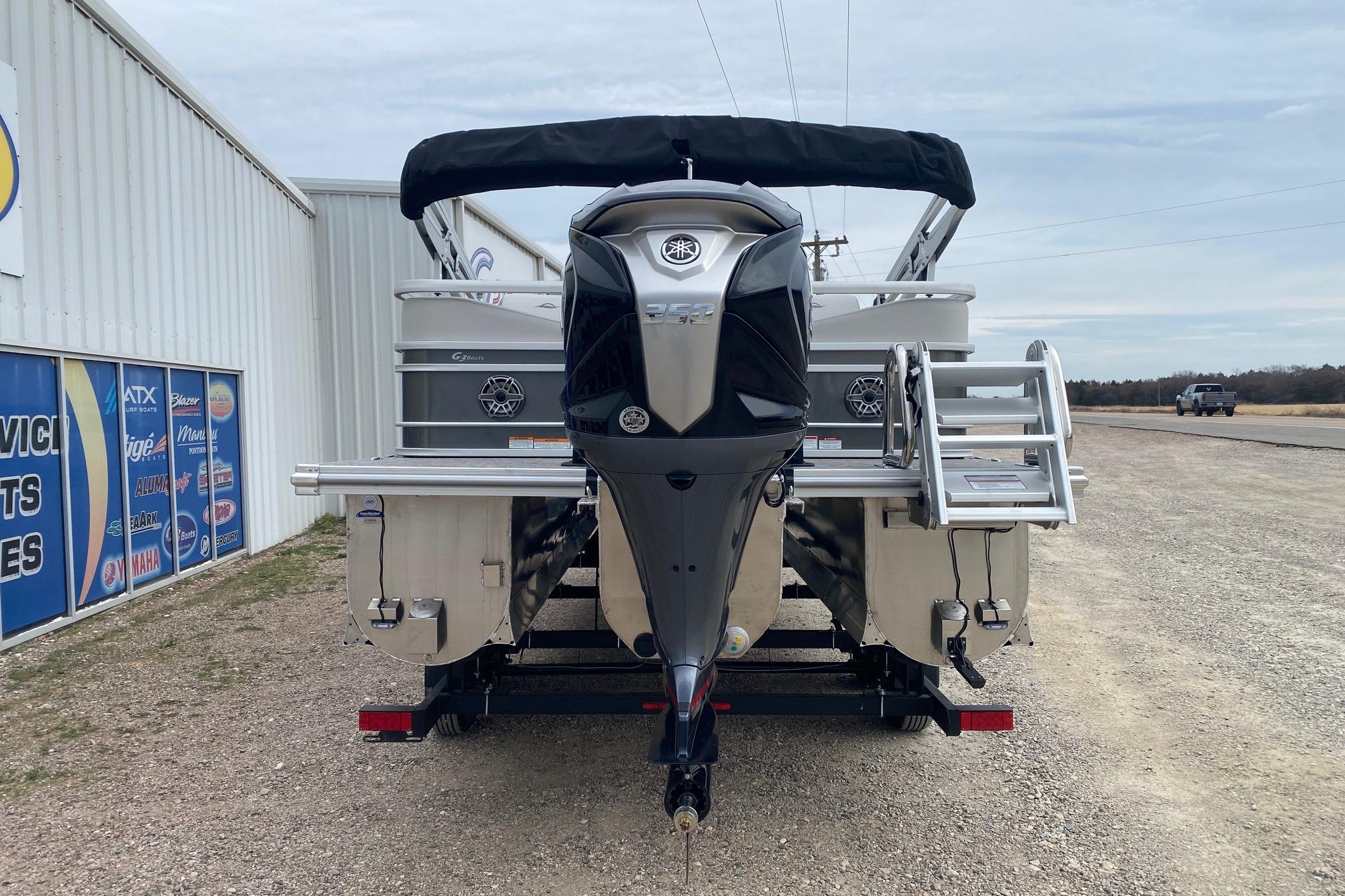 2026 SunCatcher Diamond Elite 324 SS pontoon boat with outboard motor, parked outdoors.