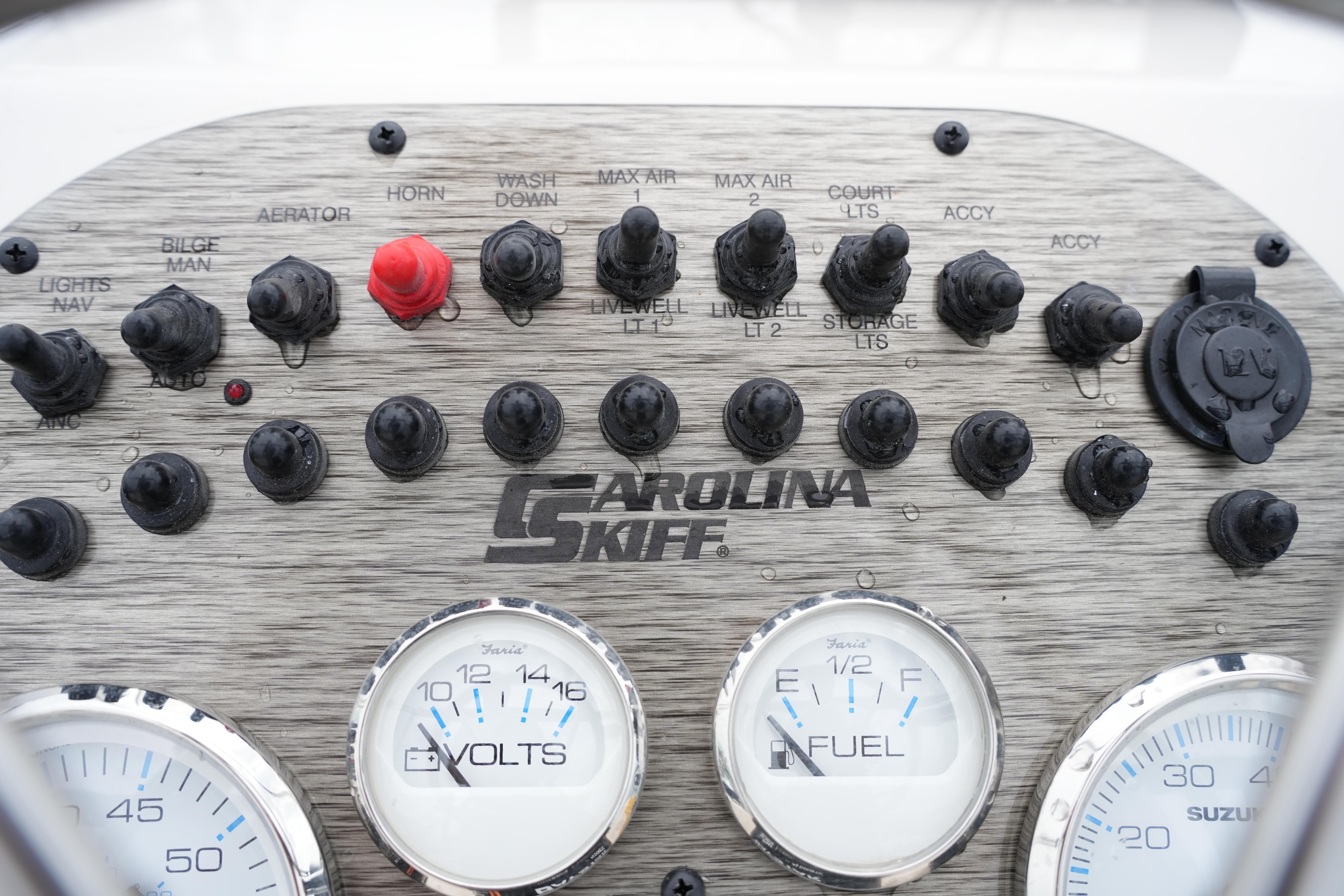 Control panel of 2025 Carolina Skiff 162 JLS boat with gauges and switches.