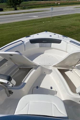 2024 Robalo R222 Center Console boat with open storage compartments.