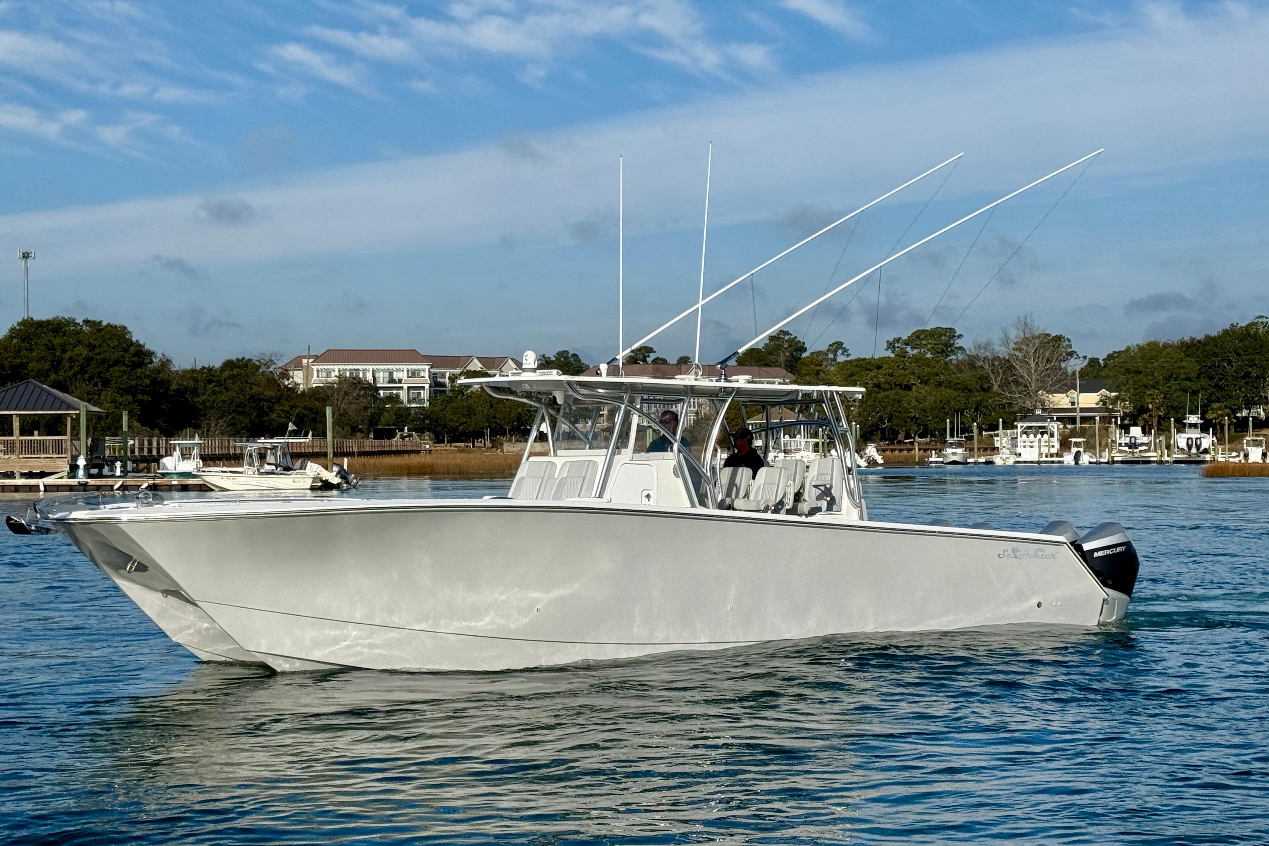 2021 SeaHunter 41 CTS boat on calm water under a clear sky.