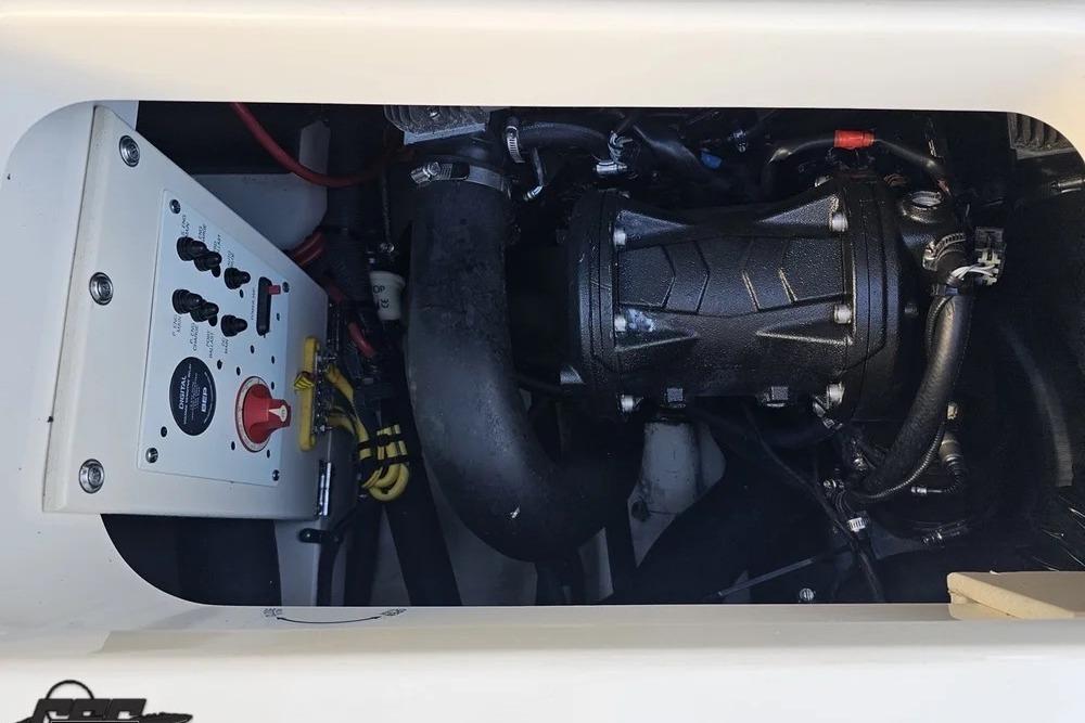 Engine compartment of a 2016 CHAPPARRAL 243 boat, showcasing mechanical components and control panel.