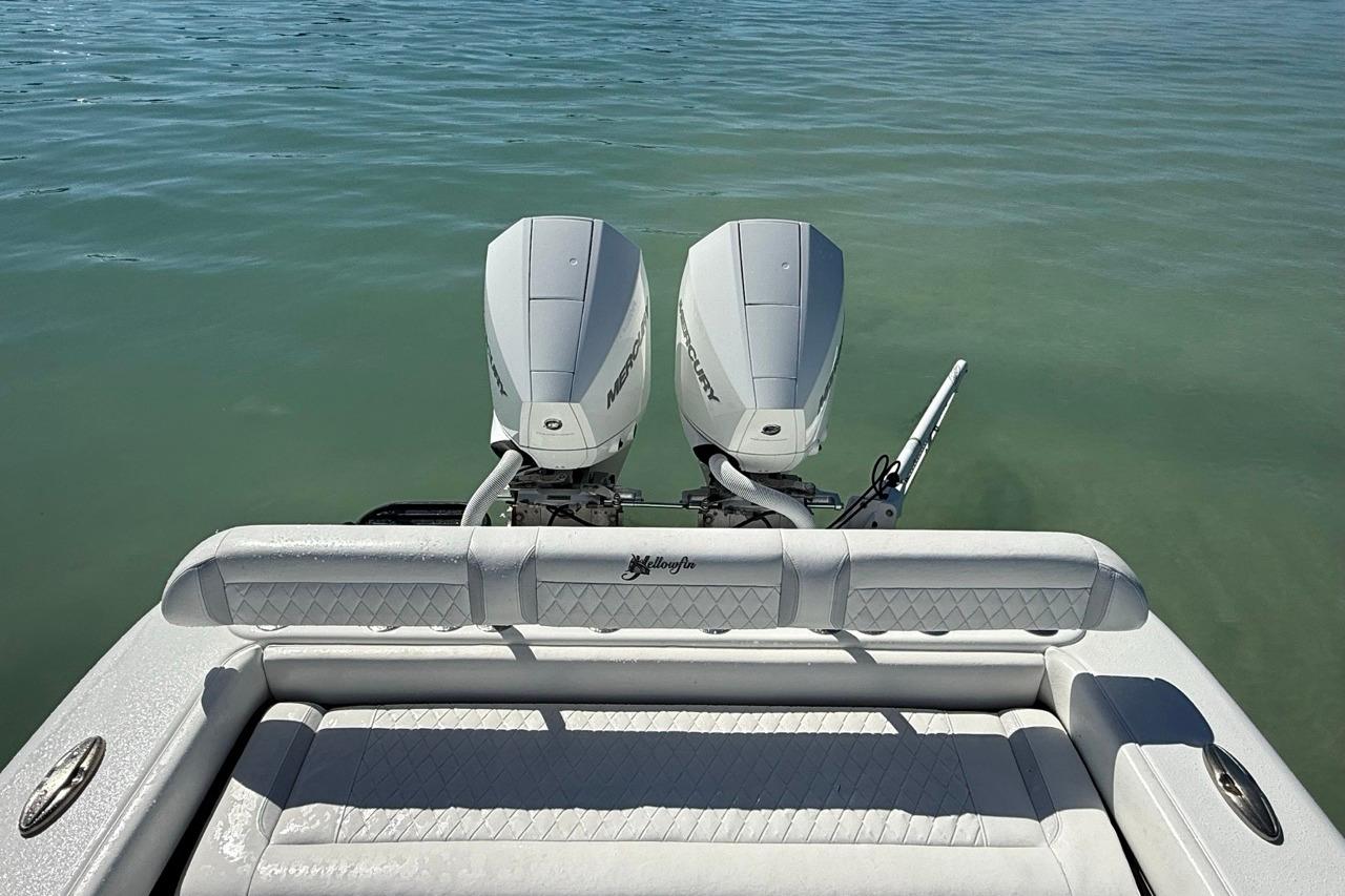 2017 Yellowfin 26 Hybrid boat with twin Mercury engines on calm water.