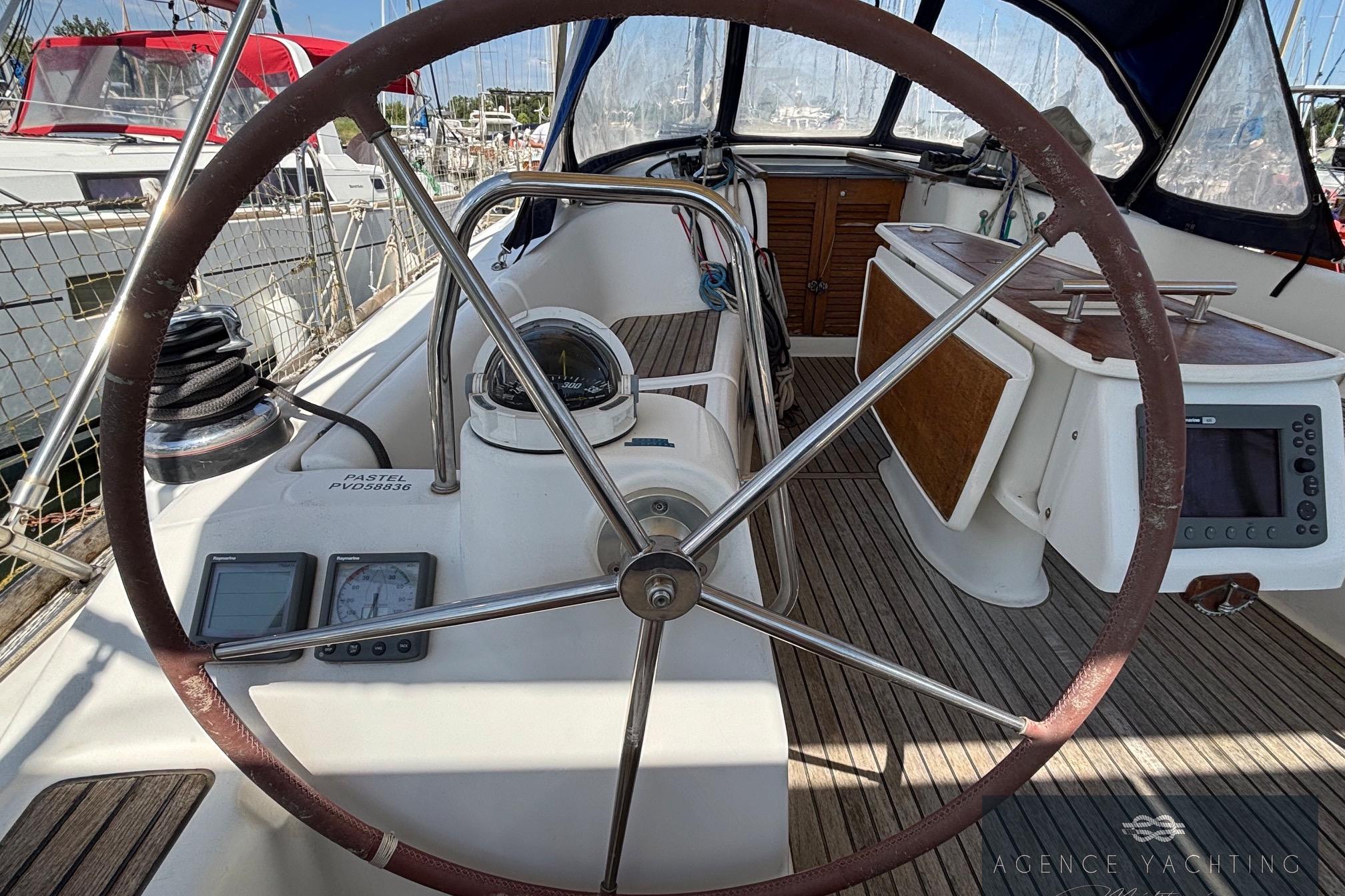 Cockpit of 2008 Beneteau Oceanis 40 sailboat with steering wheel and navigation instruments.