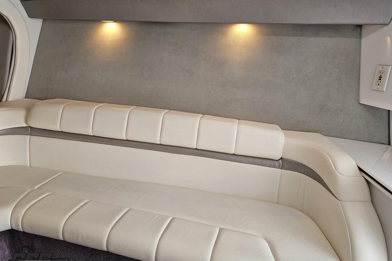 Interior of 2002 Formula 382 FASTech boat with white leather seating and ambient lighting.