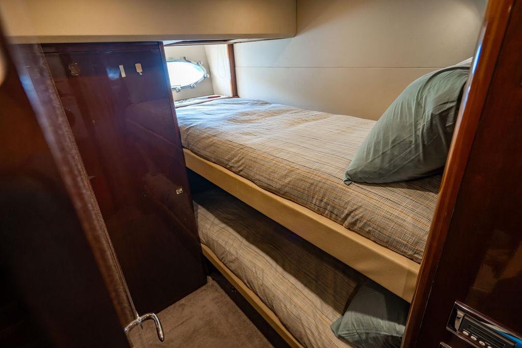 Bunk beds in 2010 Princess 95 Motor Yacht cabin with window view.
