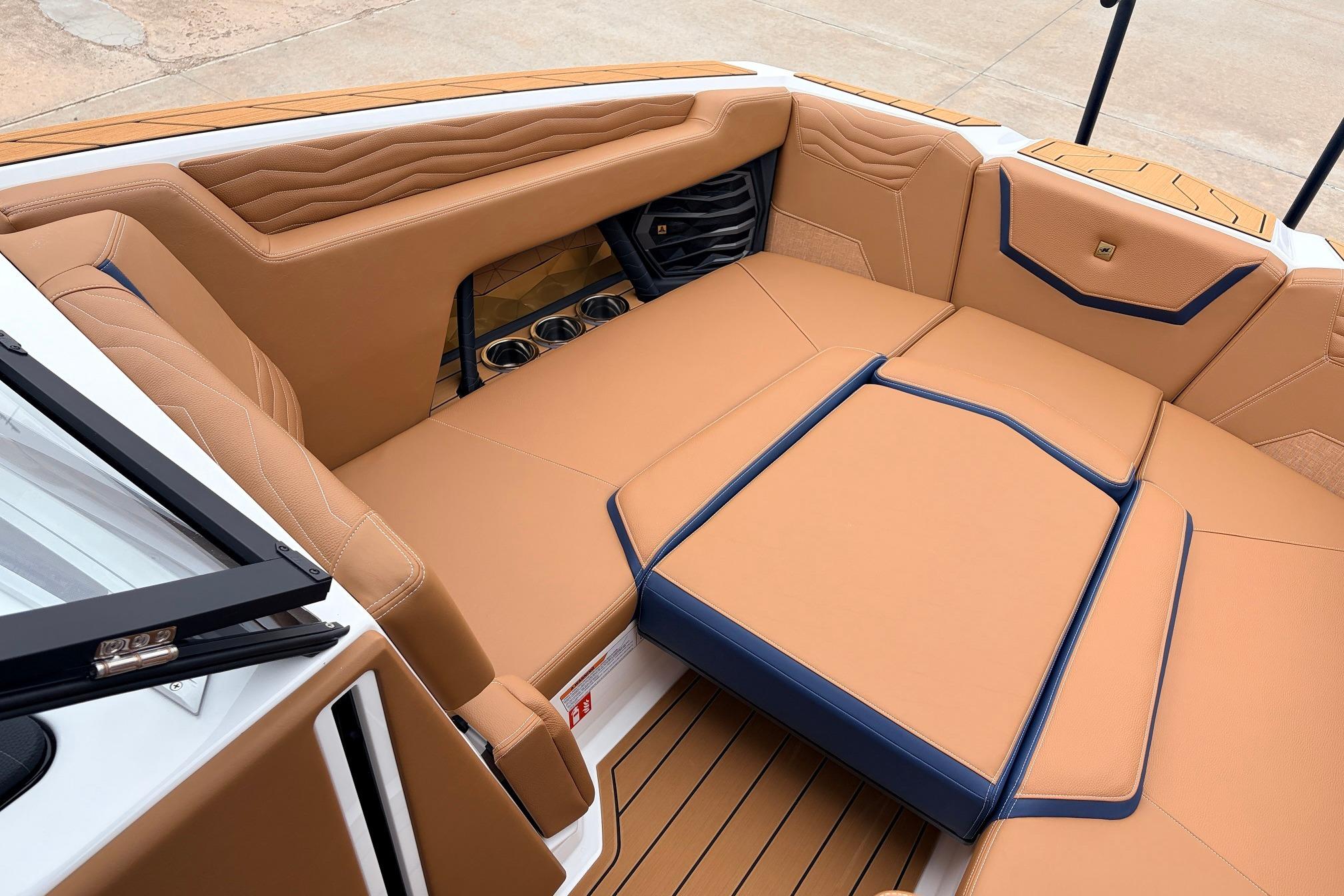 Luxurious interior of 2026 Nautique Super Air Nautique G25 boat with tan seating.