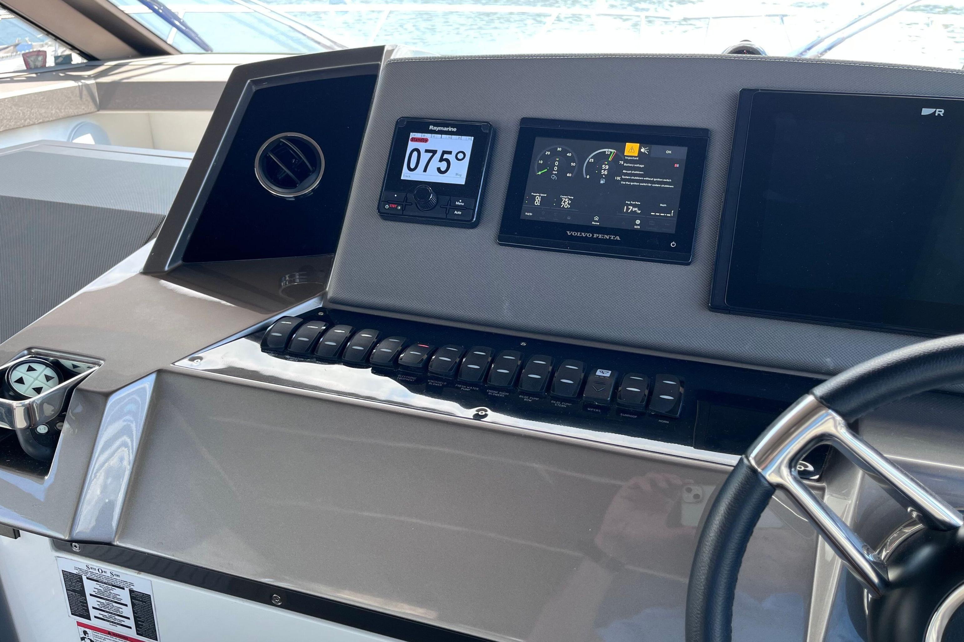 Helm of 2024 Galeon 425 HTS yacht with modern navigation displays and controls.
