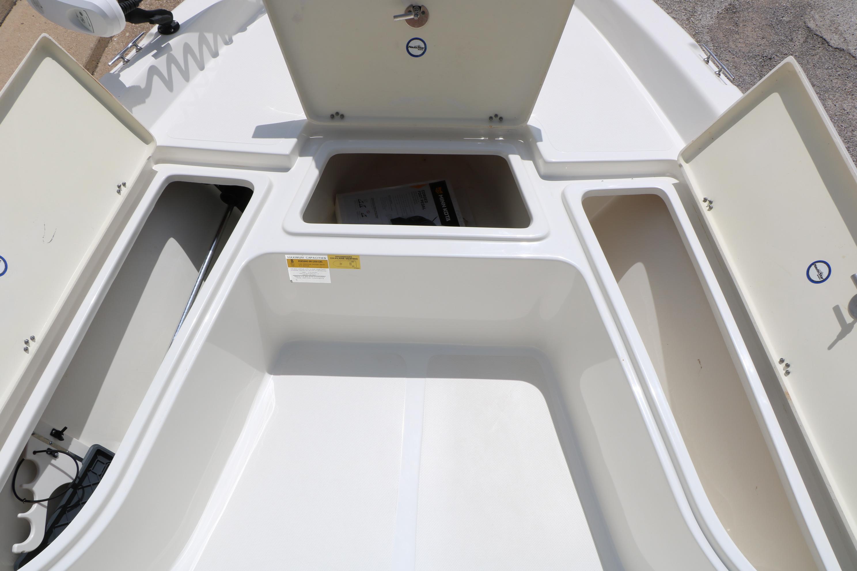 2020 NauticStar 2140 Sport boat storage compartments, open and empty, showcasing interior space.