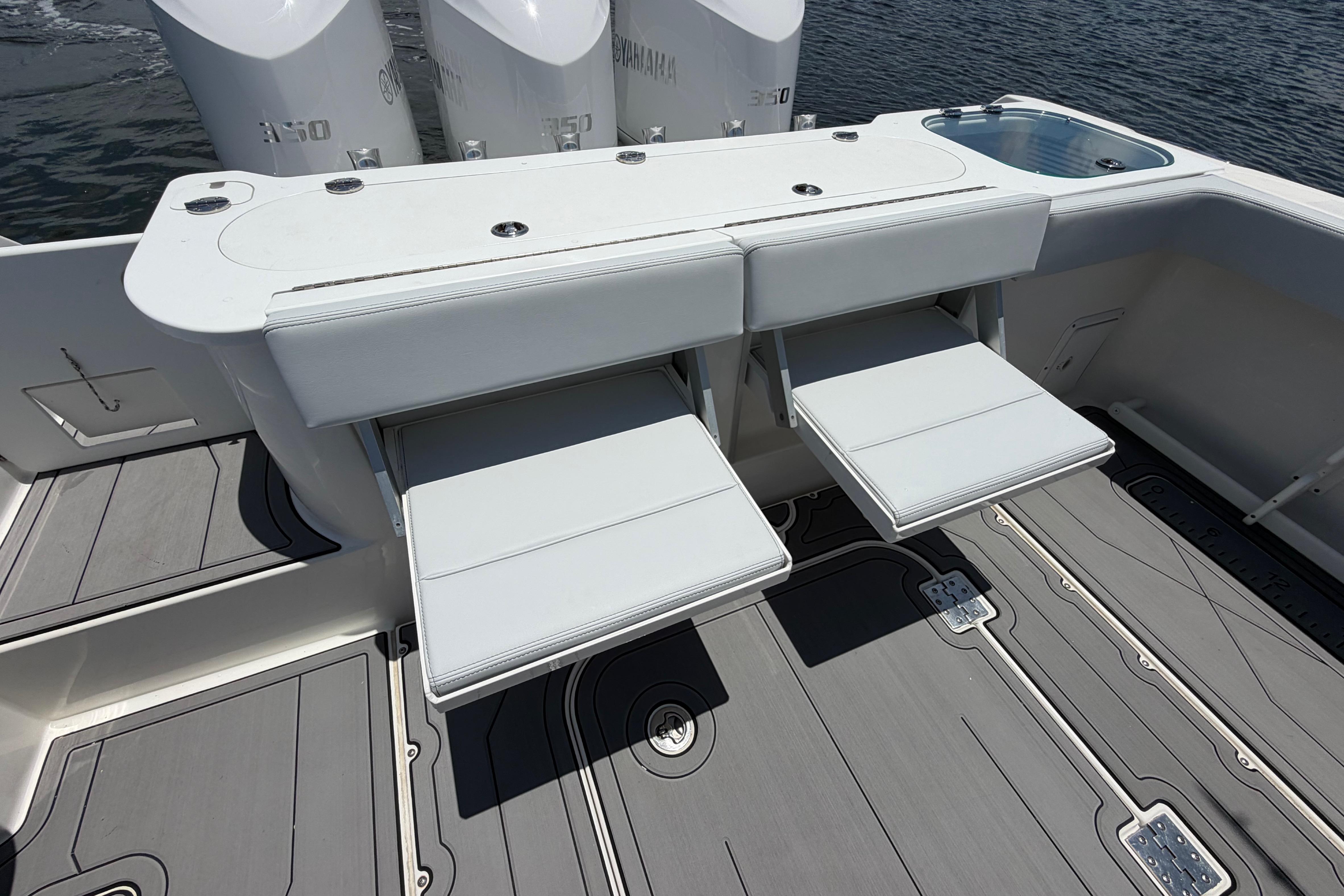 2009 Everglades 350LX boat with fold-out seating and Yamaha engines on water.