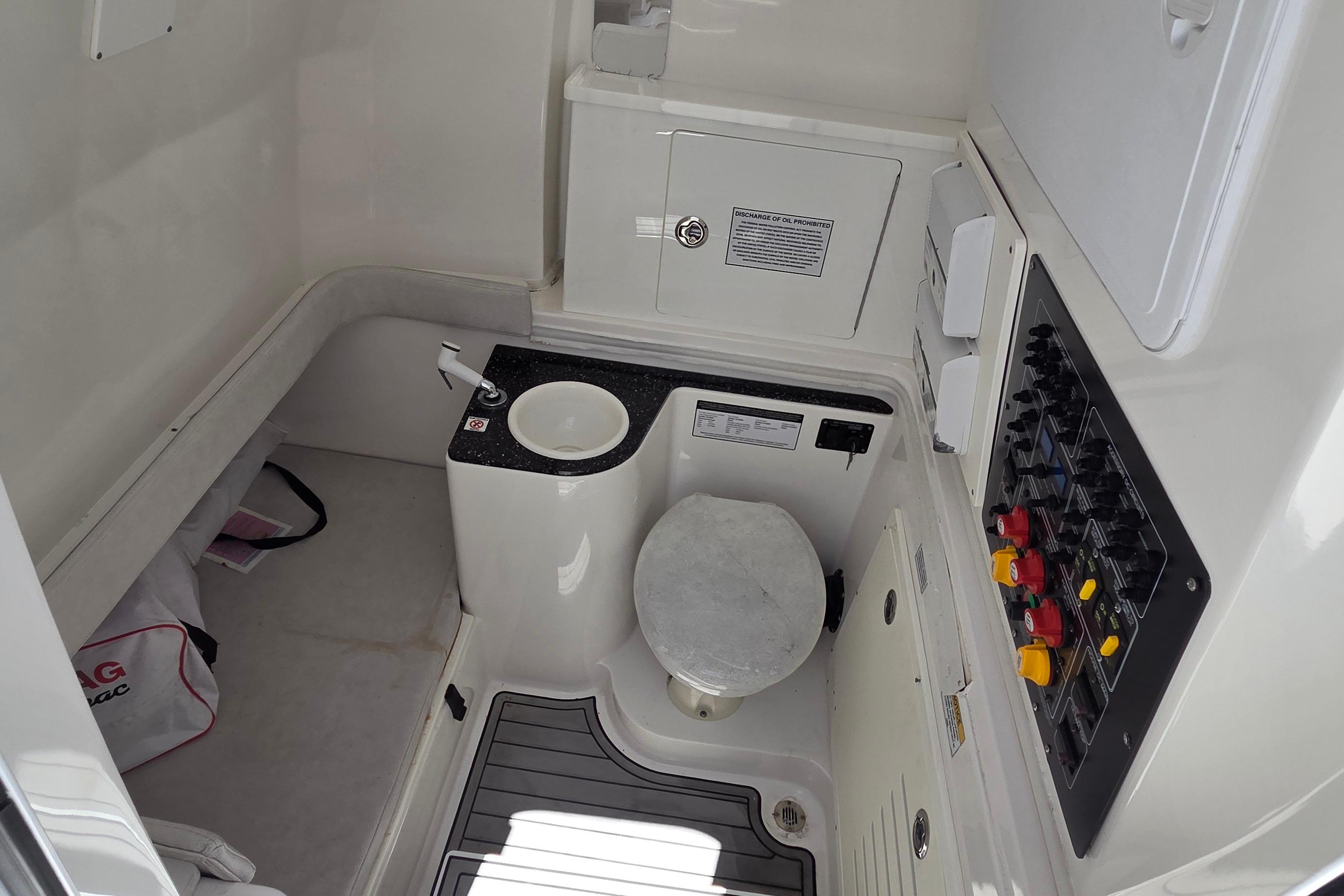 2021 Sea Fox 328 Commander boat interior with toilet and control panel.