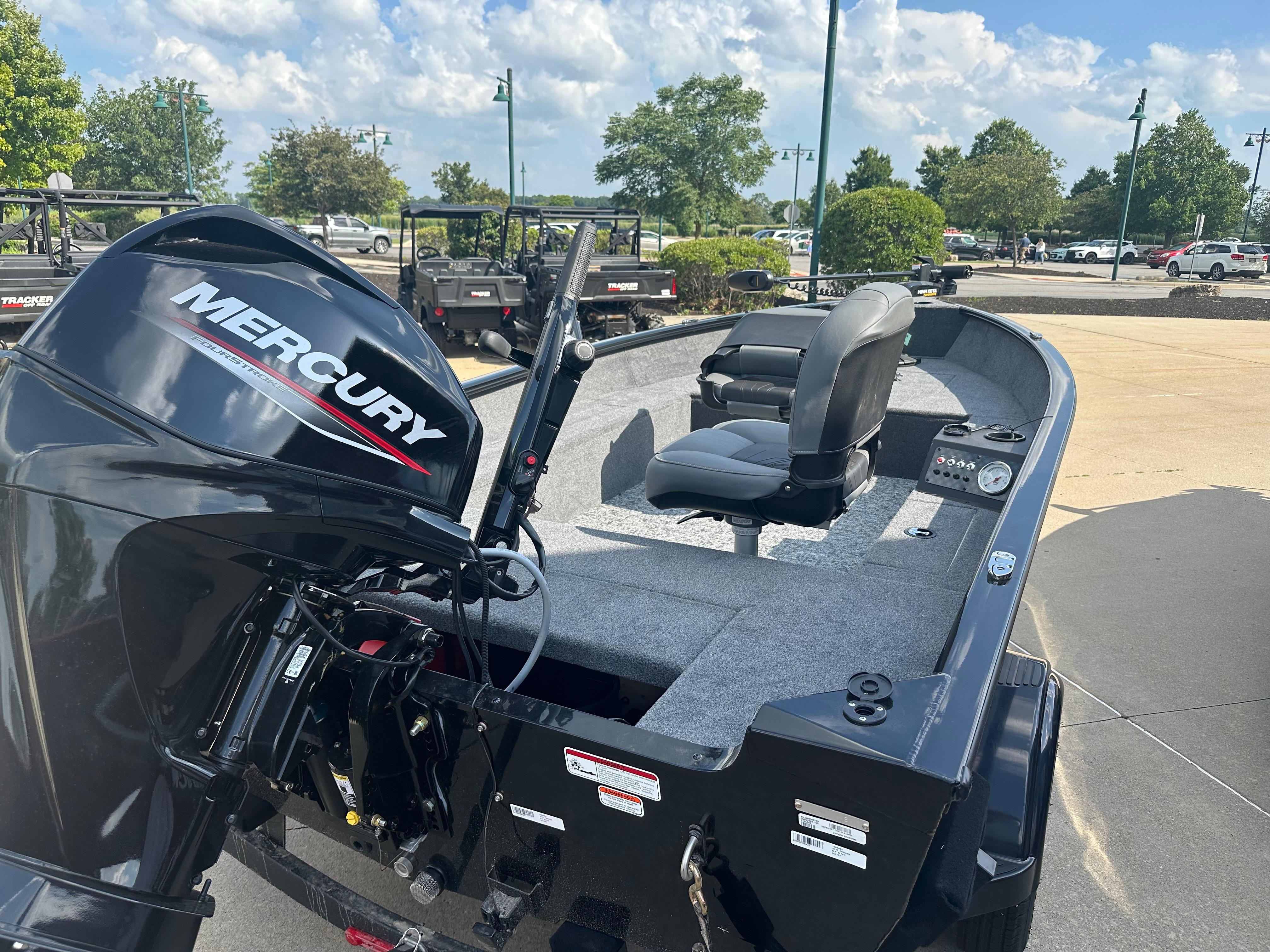 2025 Tracker Super Guide V-16 T boat with Mercury engine, parked outdoors.