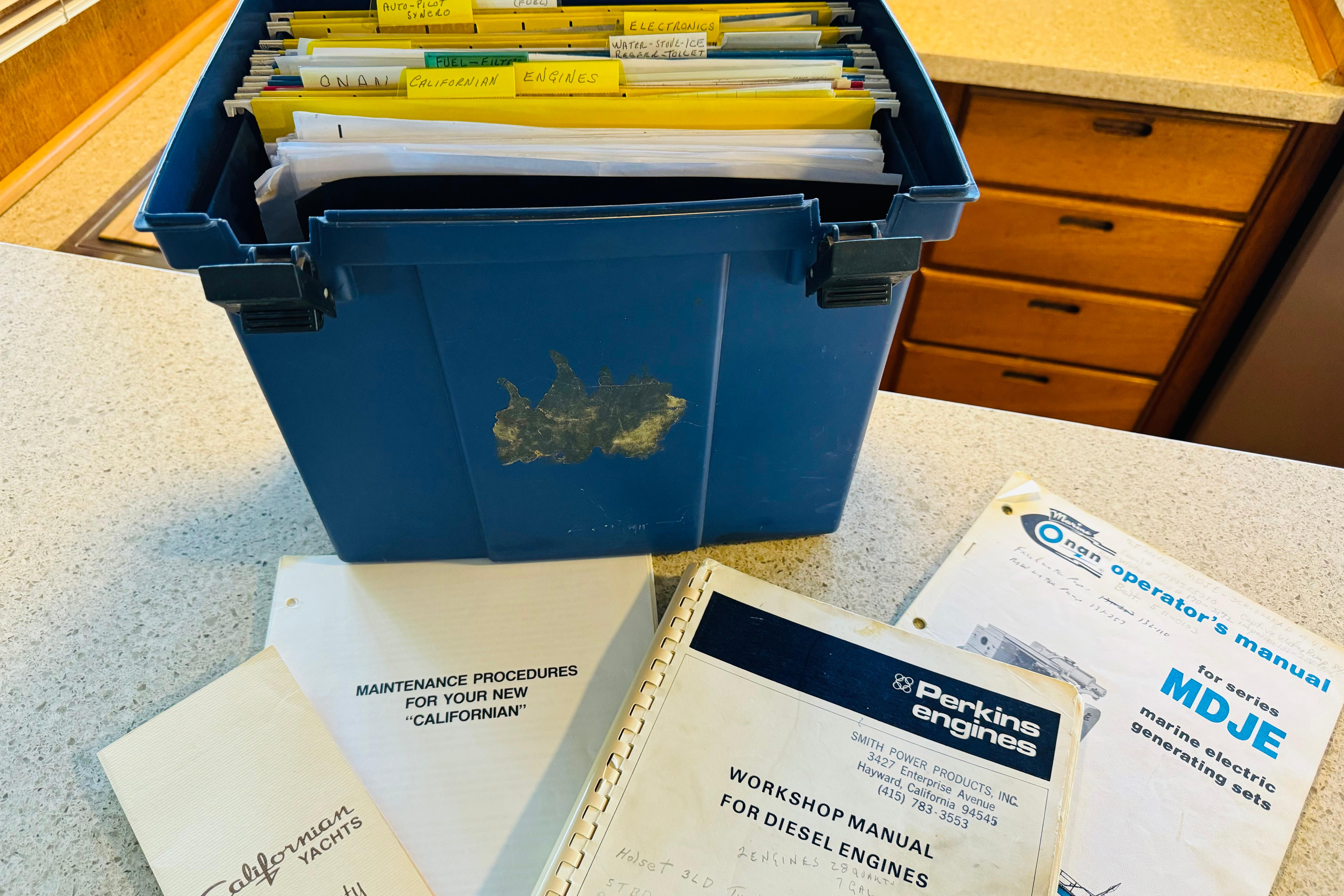 Blue box with manuals for 1978 Californian 42 LRC yacht maintenance and engine workshop.