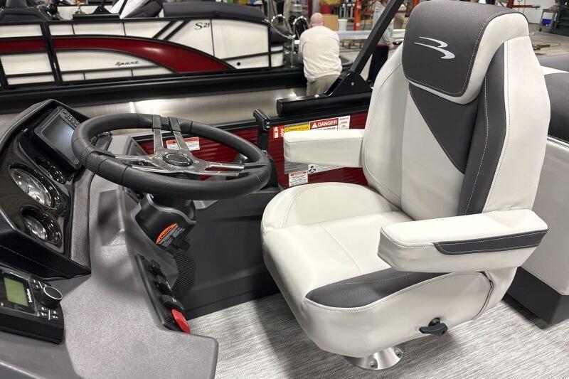 2026 Bennington 22 SSRSF boat interior with steering wheel and captain's chair.
