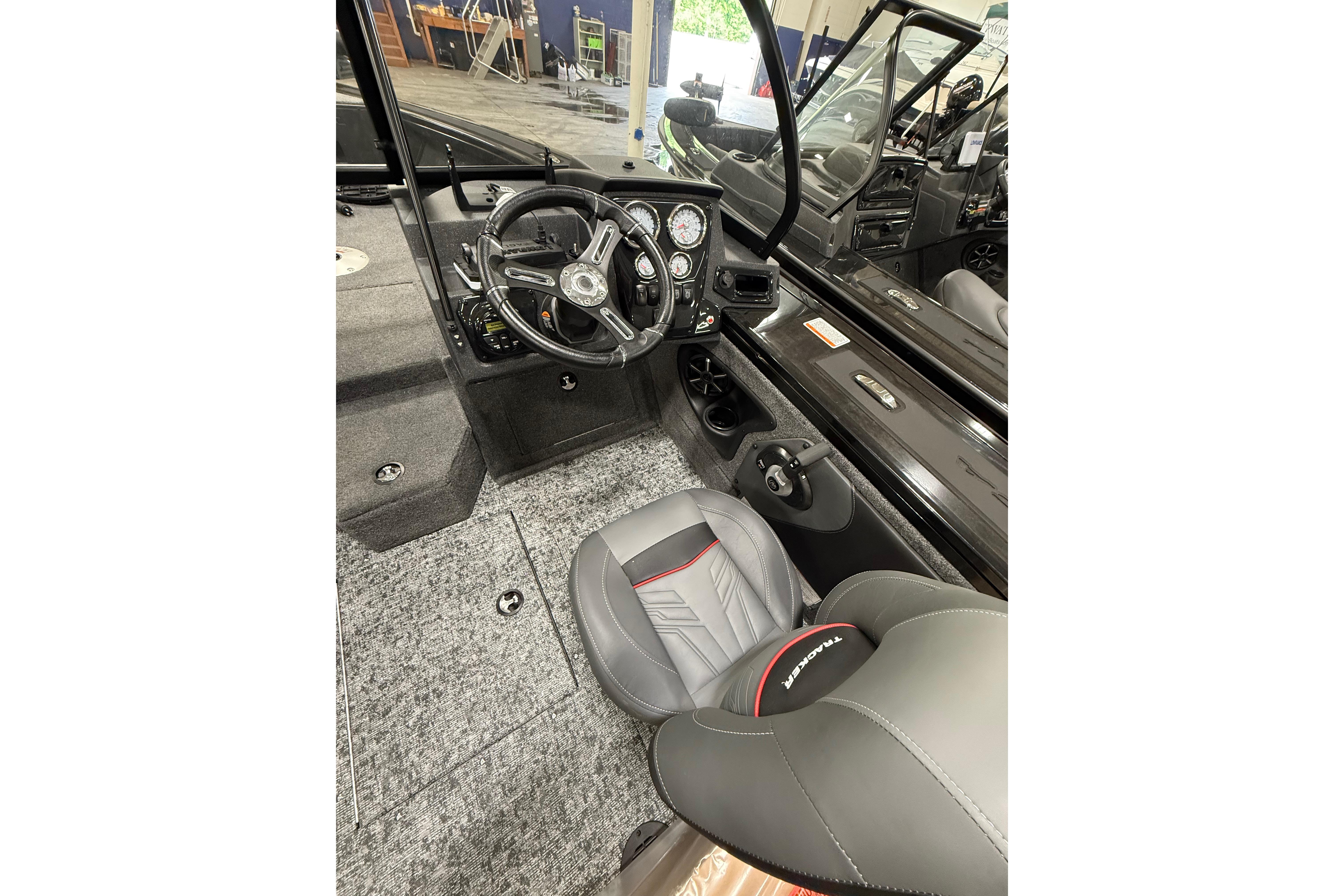 Interior of 2026 Tracker Targa V-19 WT boat, featuring steering wheel and seating.