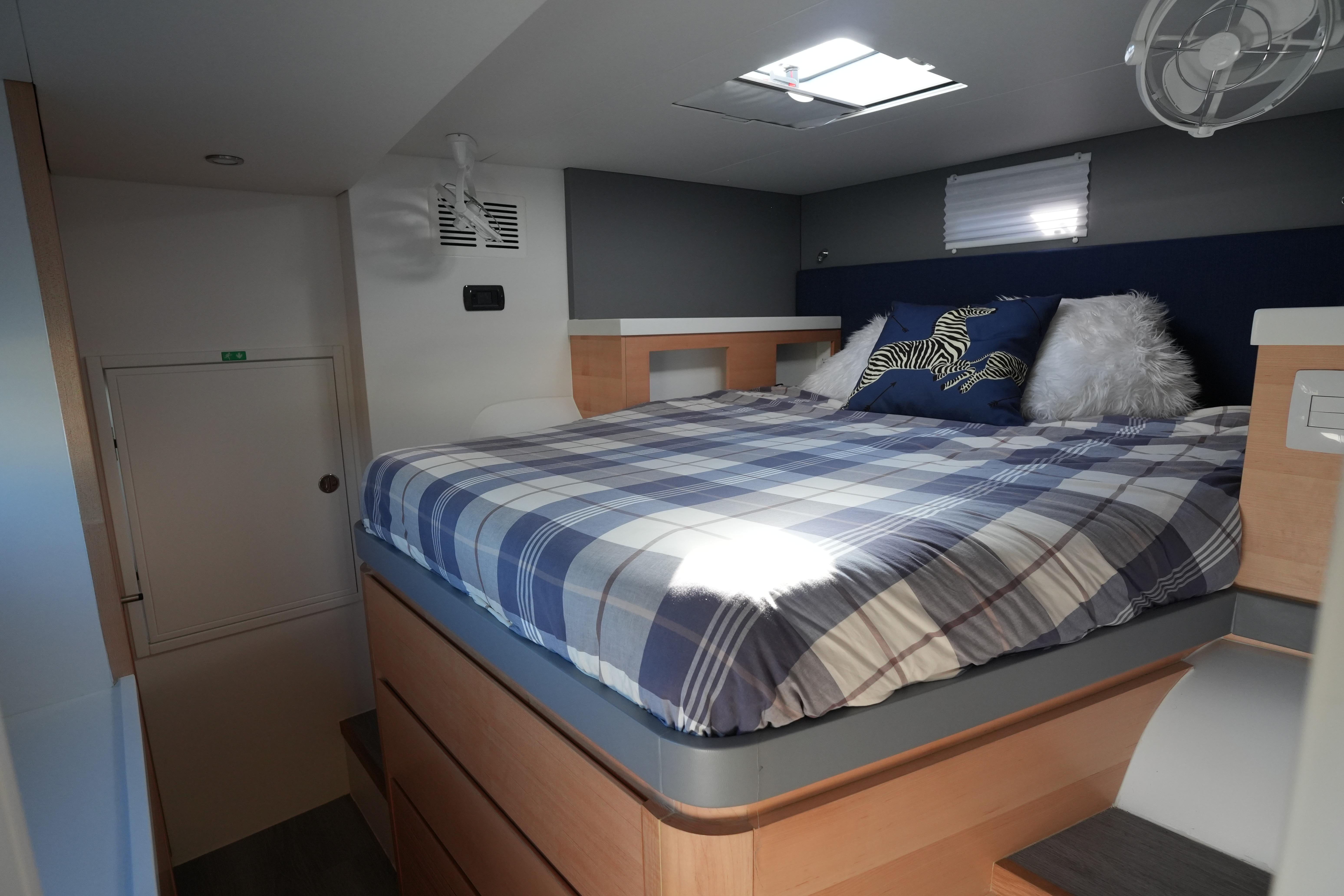 2024 Balance 442 interior with cozy bed, plaid bedding, and modern design elements.