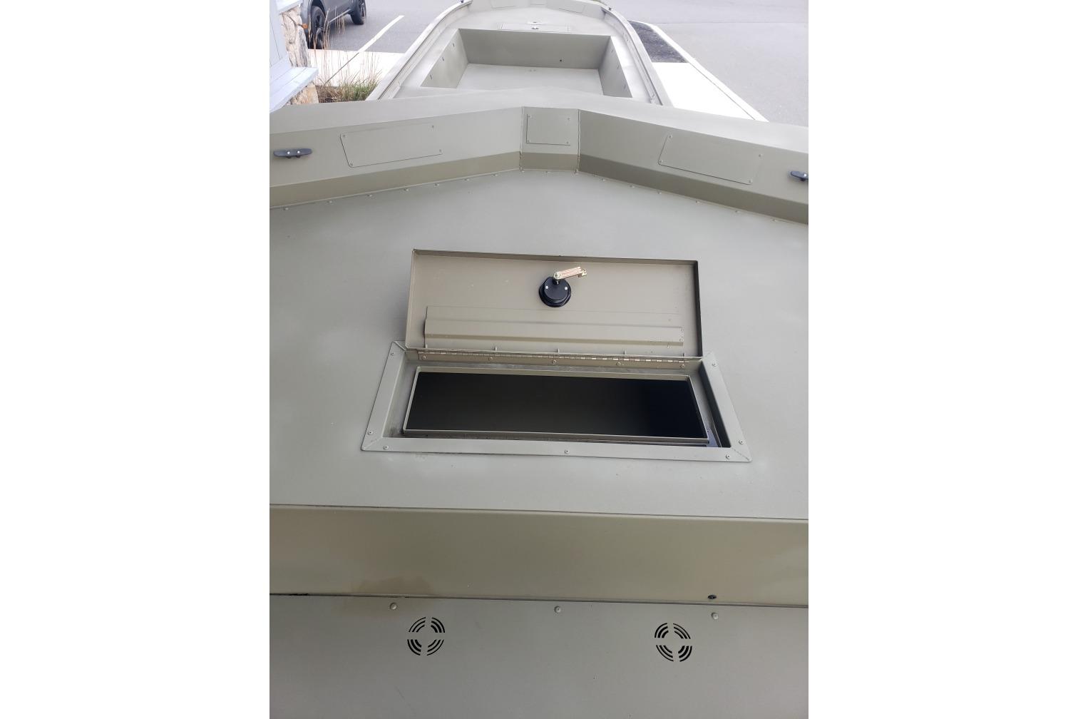 2025 Tracker Grizzly 2072 Utility boat with open storage compartment.