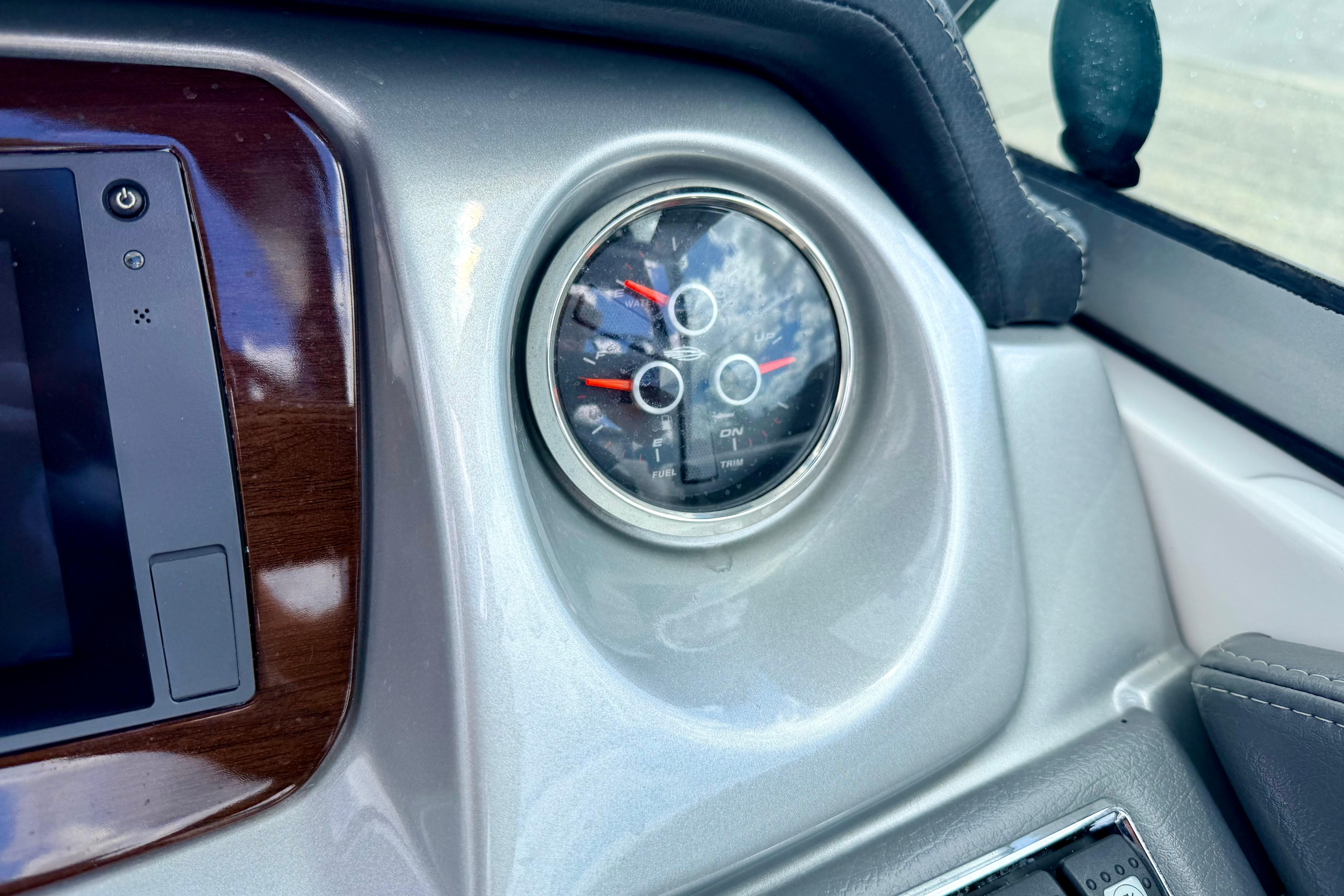 Dashboard of a 2015 Chaparral Sunesta 264 boat with gauge and controls.