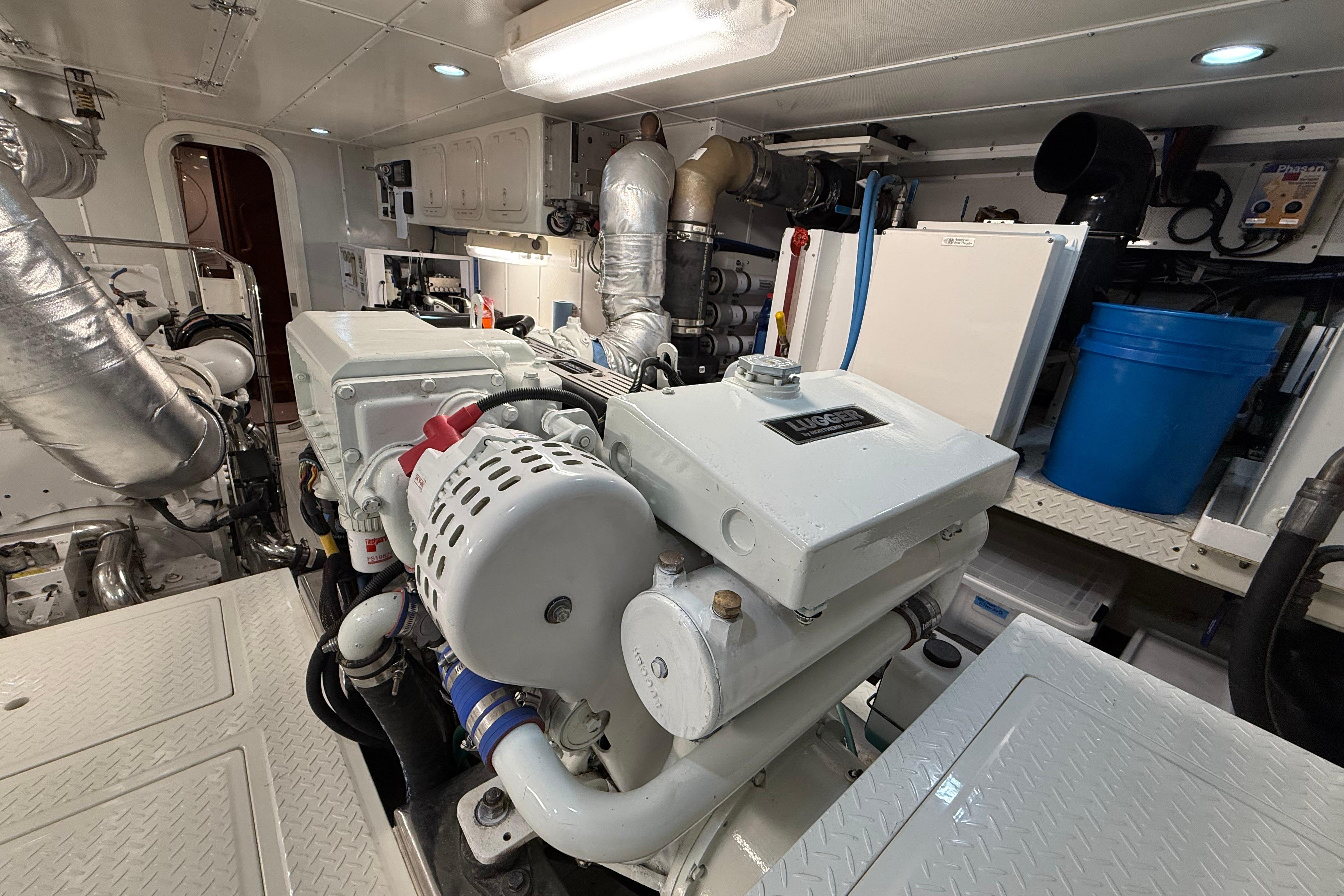 Engine room of a 2009 Nordhavn N64 yacht, featuring mechanical equipment and storage.