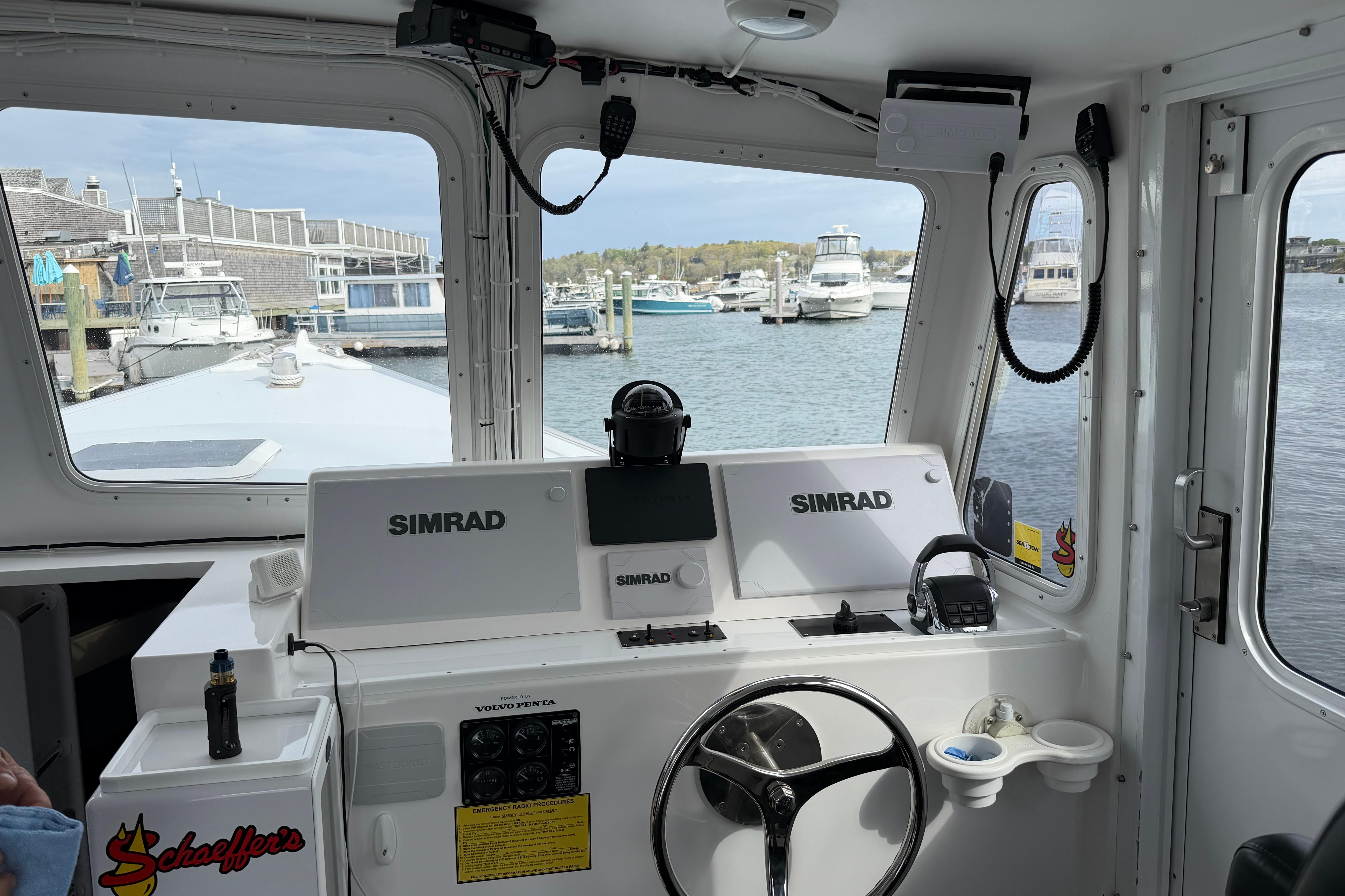 Interior view of 2018 H&H Marine Osmond Beal boat with Simrad navigation system.