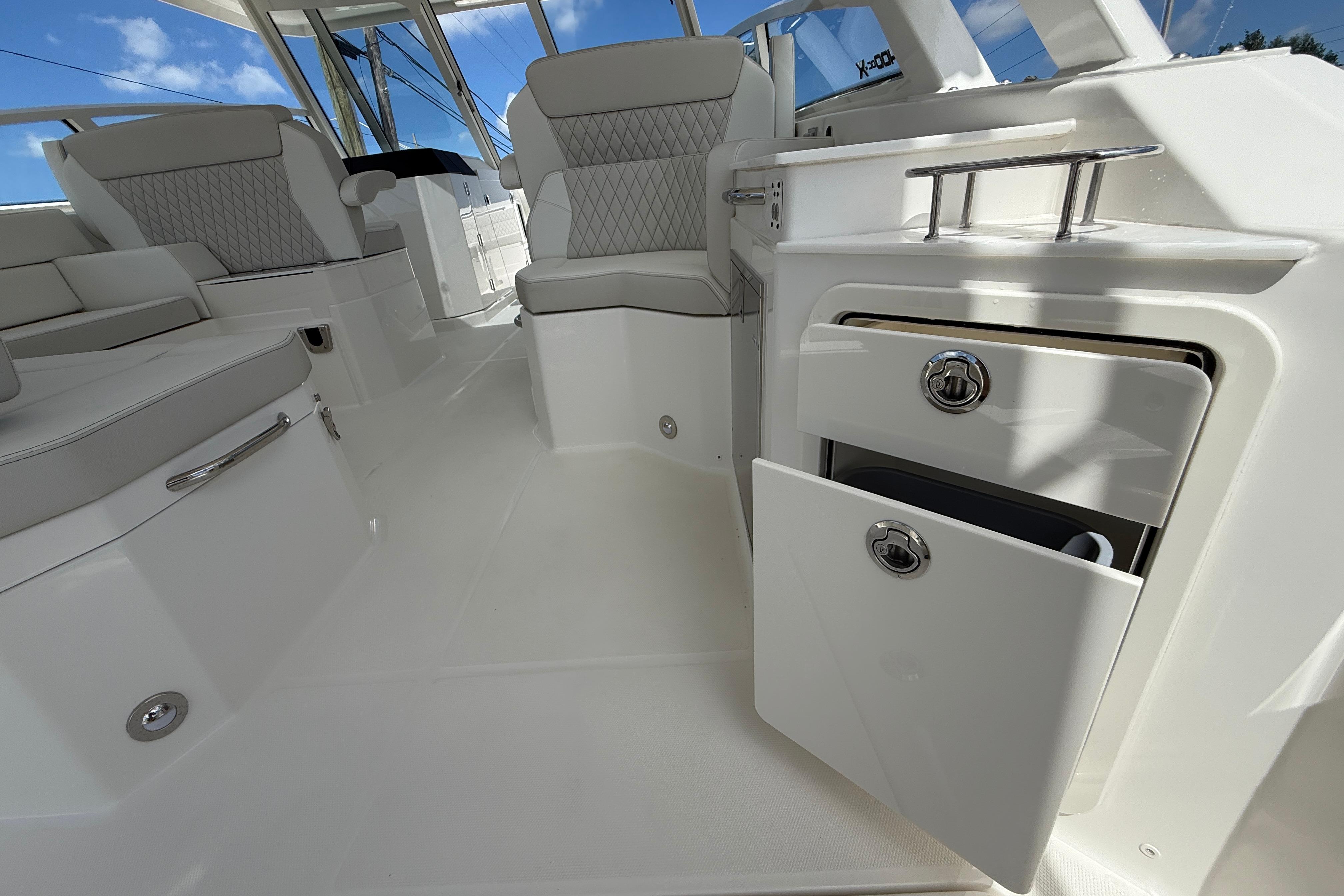 Luxurious interior of 2026 World Cat 400 DC-X Island boat with seating and storage.