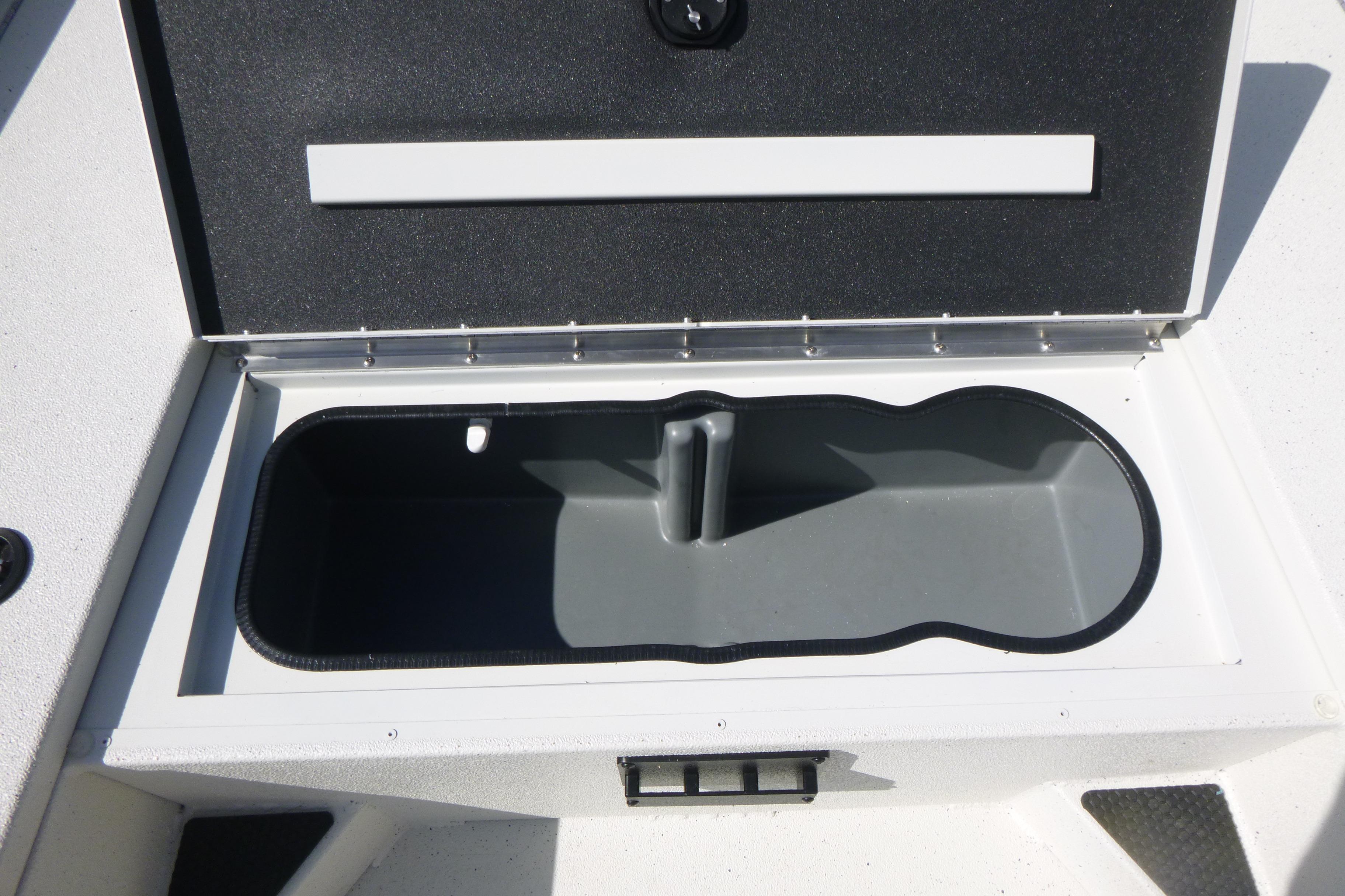 Open storage compartment on 2025 Ranger RB210 boat, showcasing interior design.