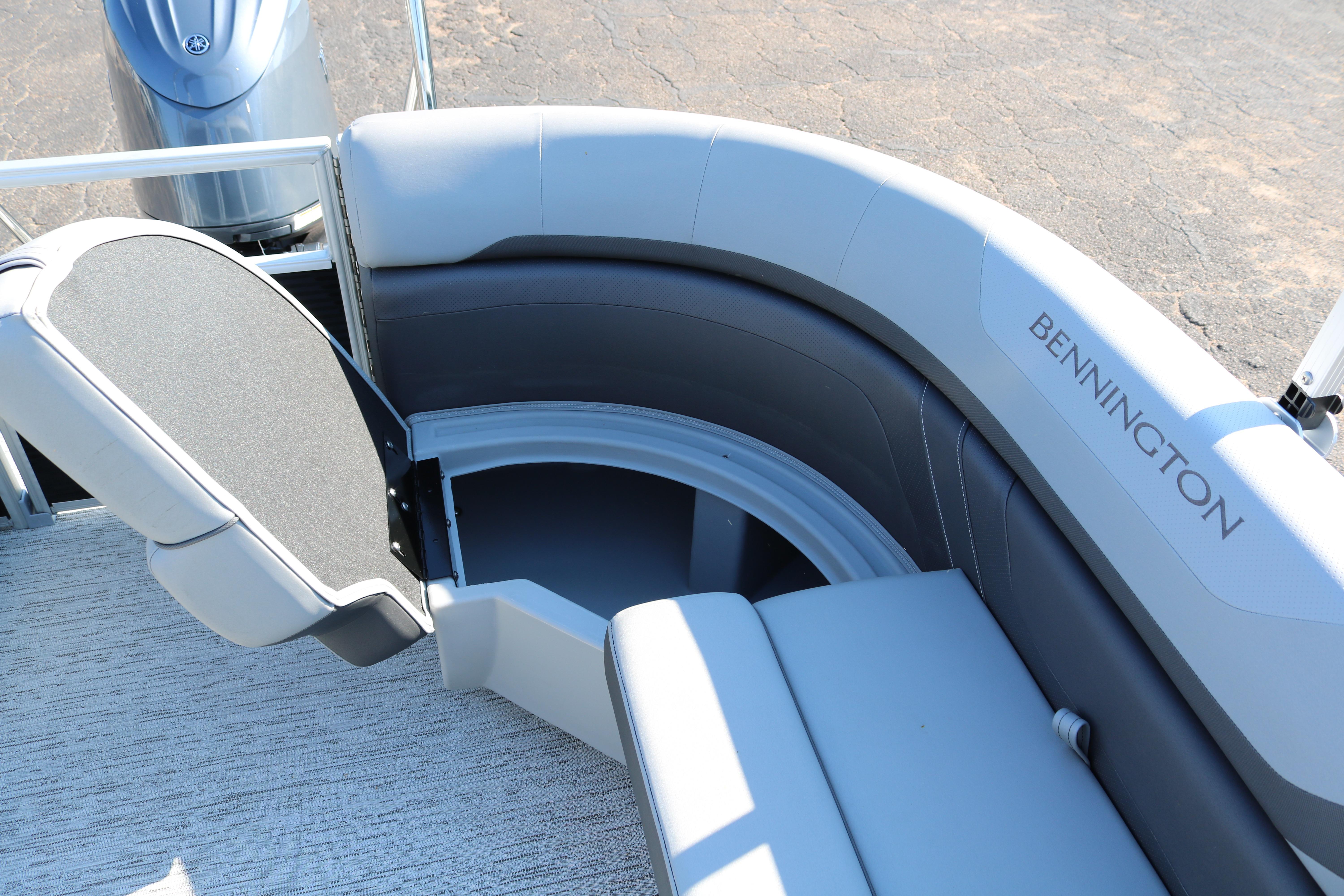 2026 Bennington 22SX Stern Radius boat seating with storage compartment open.