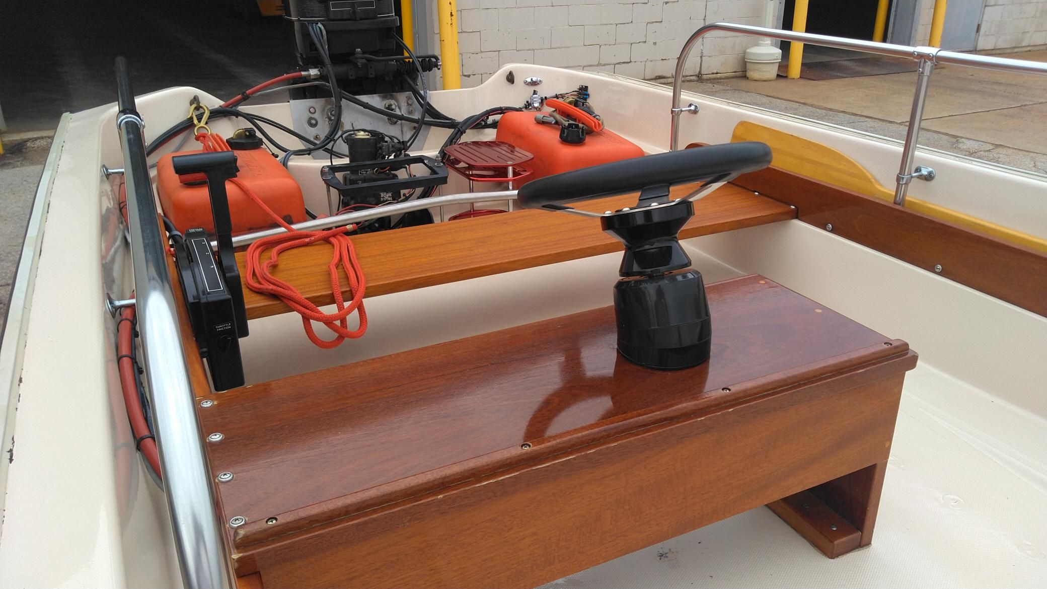 Interior of a 1976 Boston Whaler Sport 15 boat with wooden details.